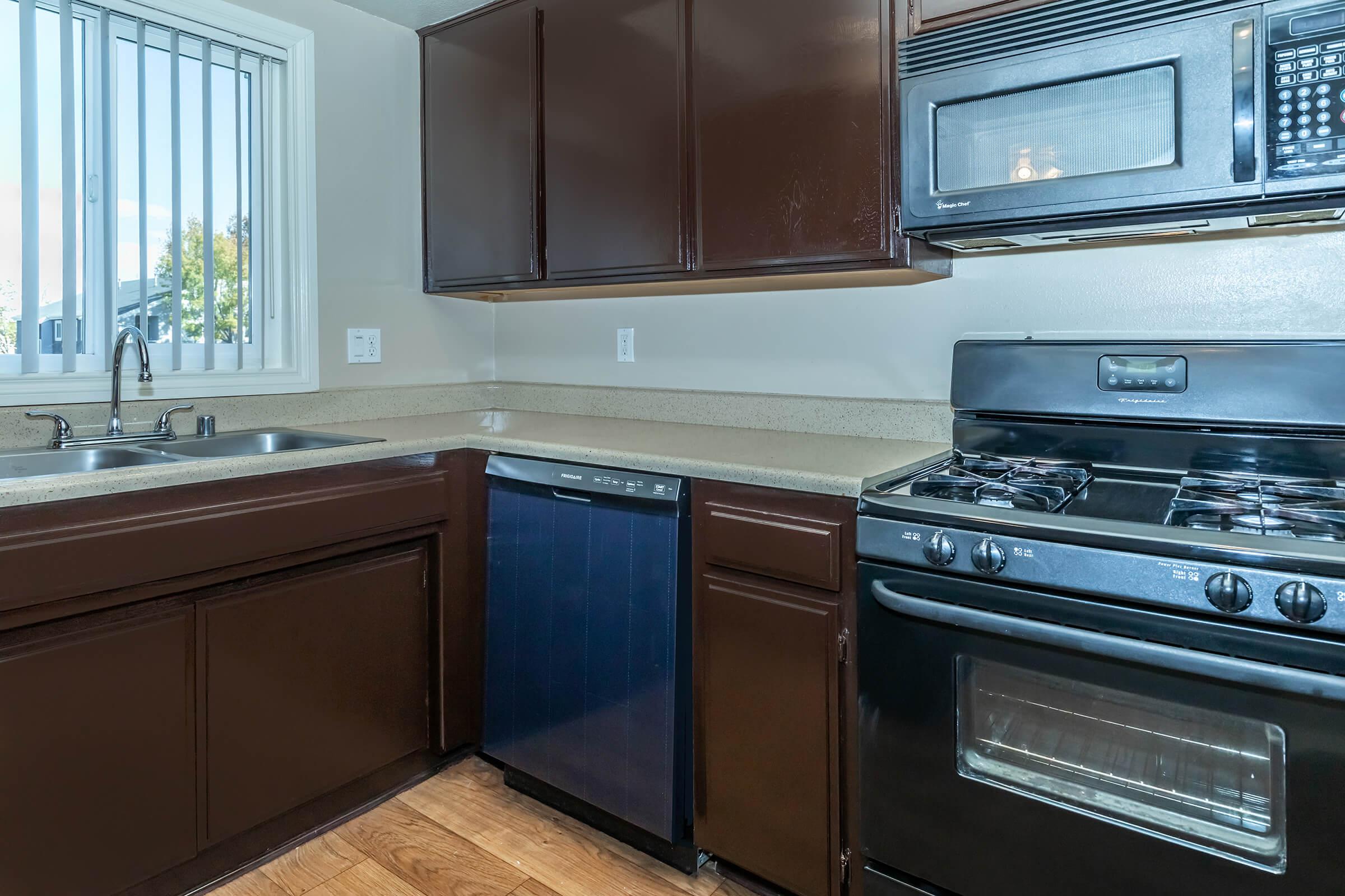 a stove top oven sitting inside of a kitchen