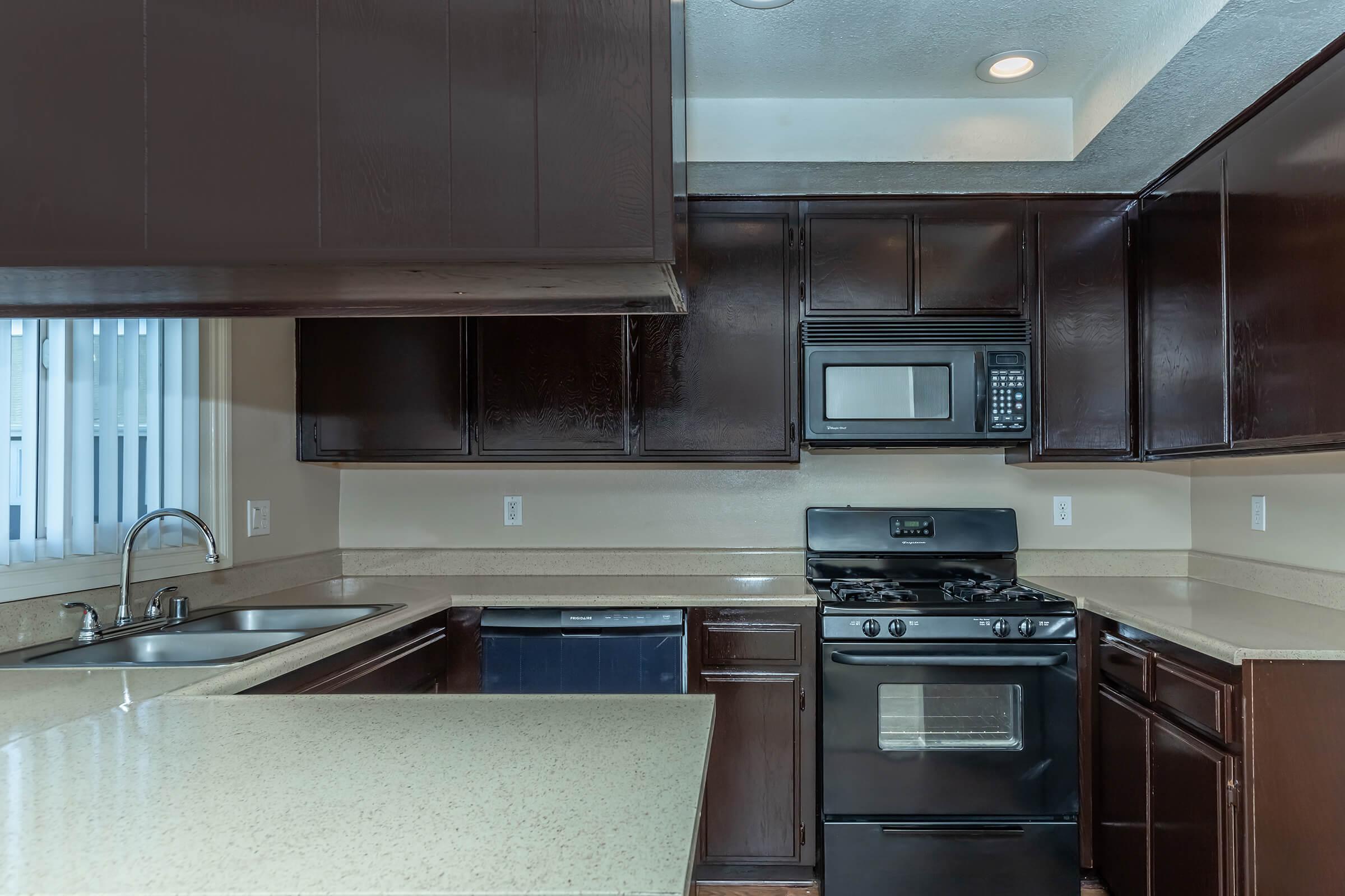 a stove top oven sitting inside of a kitchen