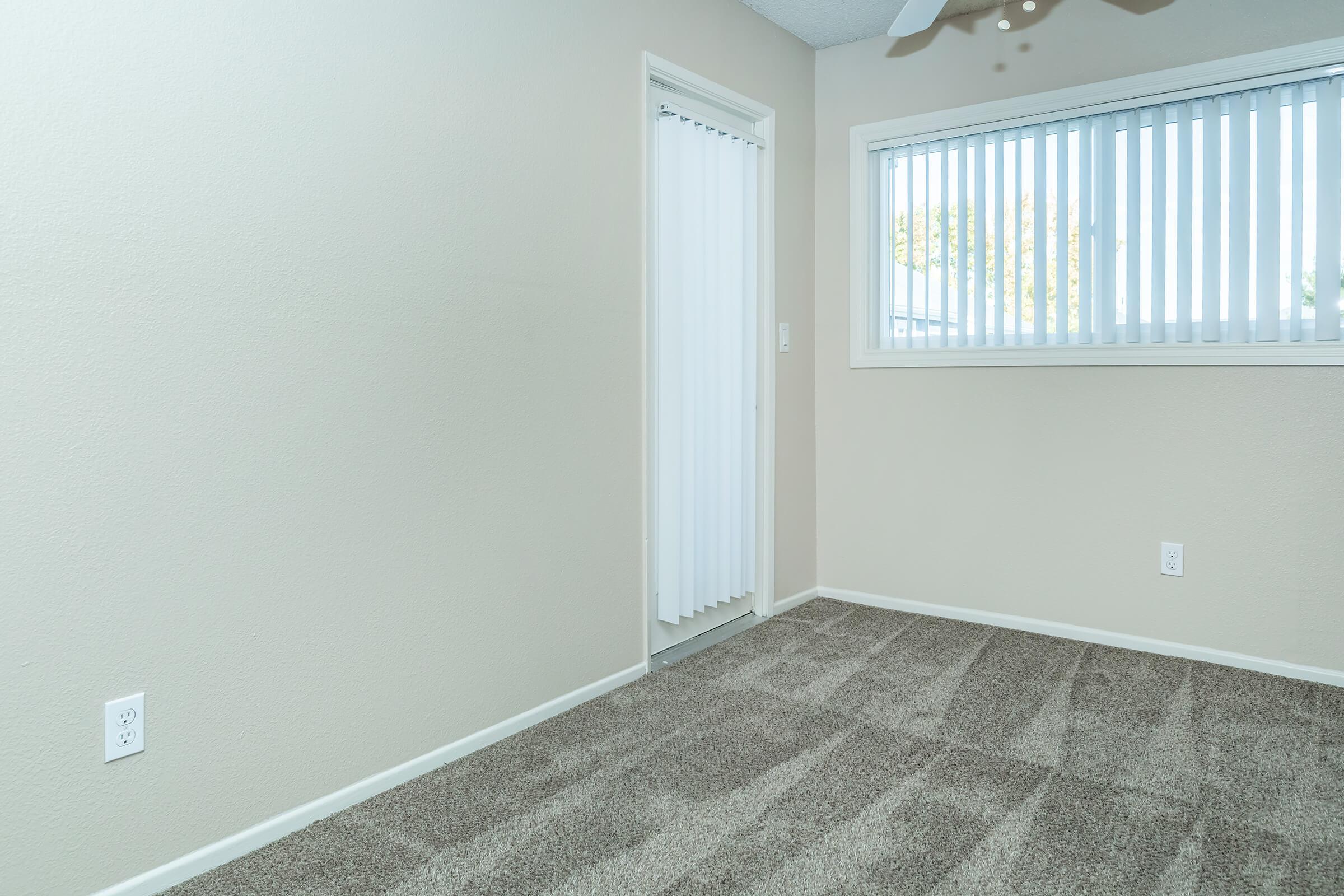 a bedroom with a large window