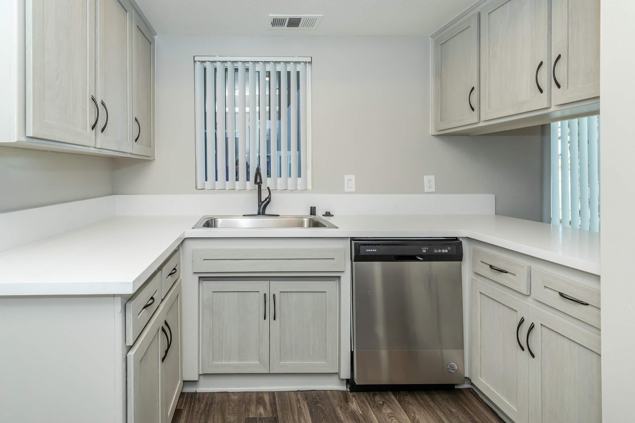 a kitchen with a stove sink and refrigerator