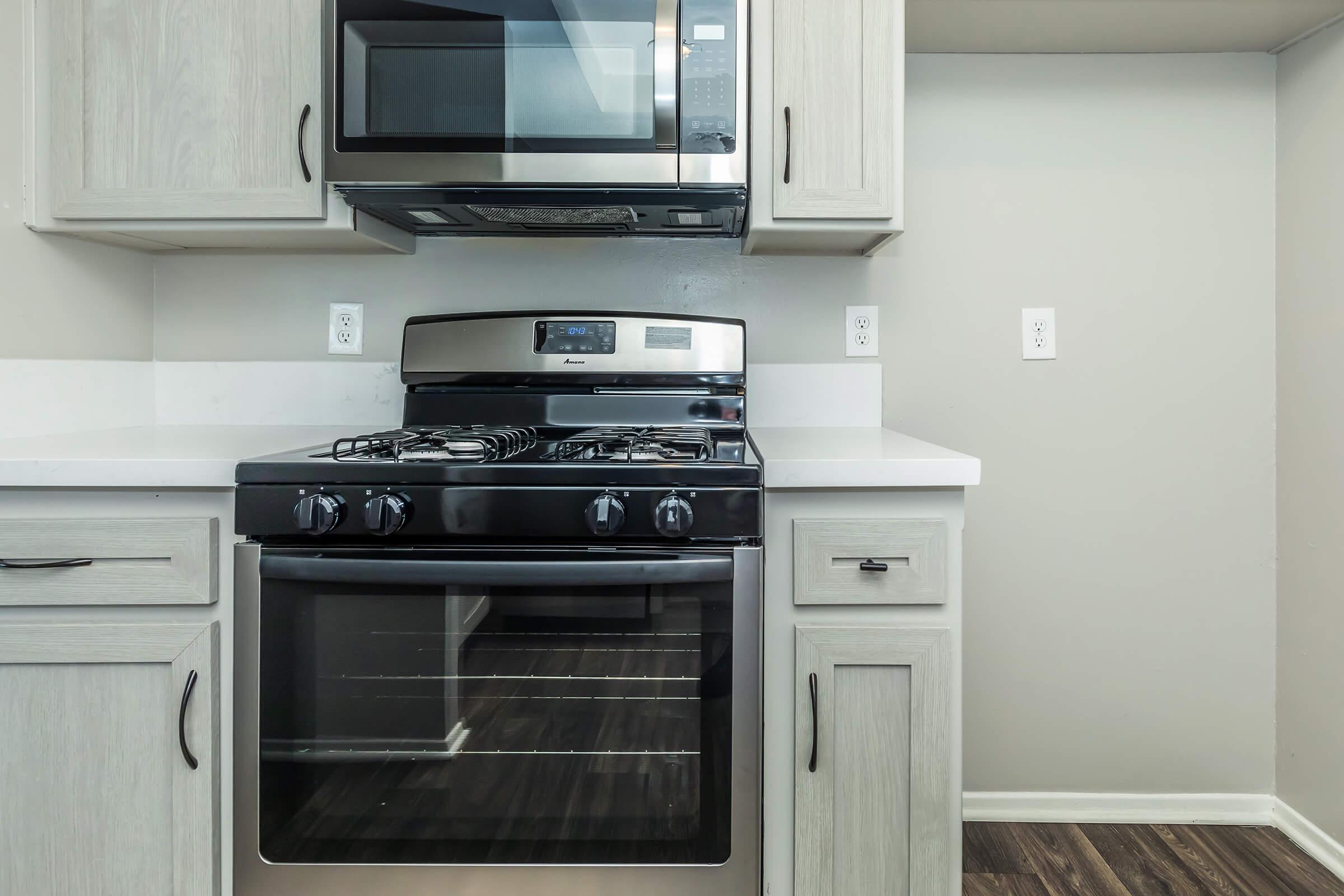 a stove top oven sitting inside of a kitchen