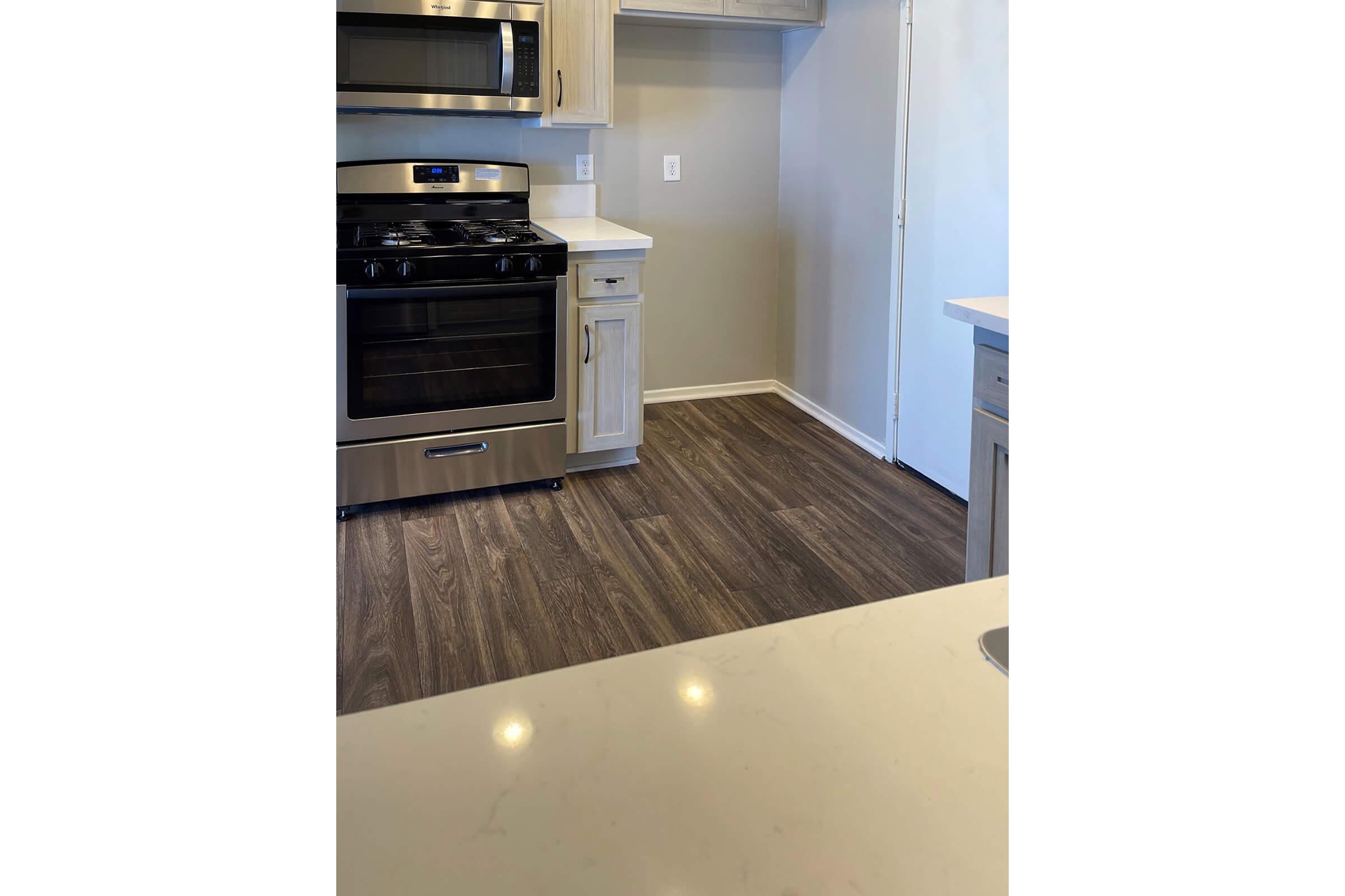 a kitchen with a stove and a refrigerator