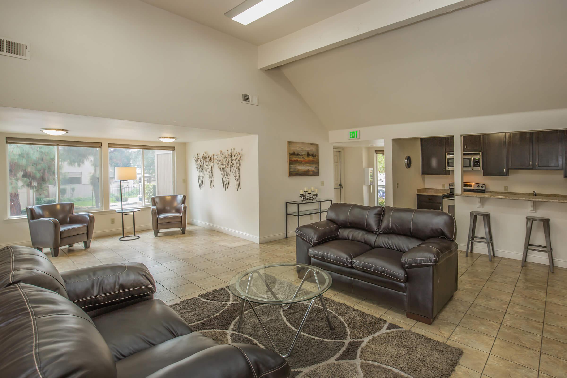 a living room filled with furniture and a large window