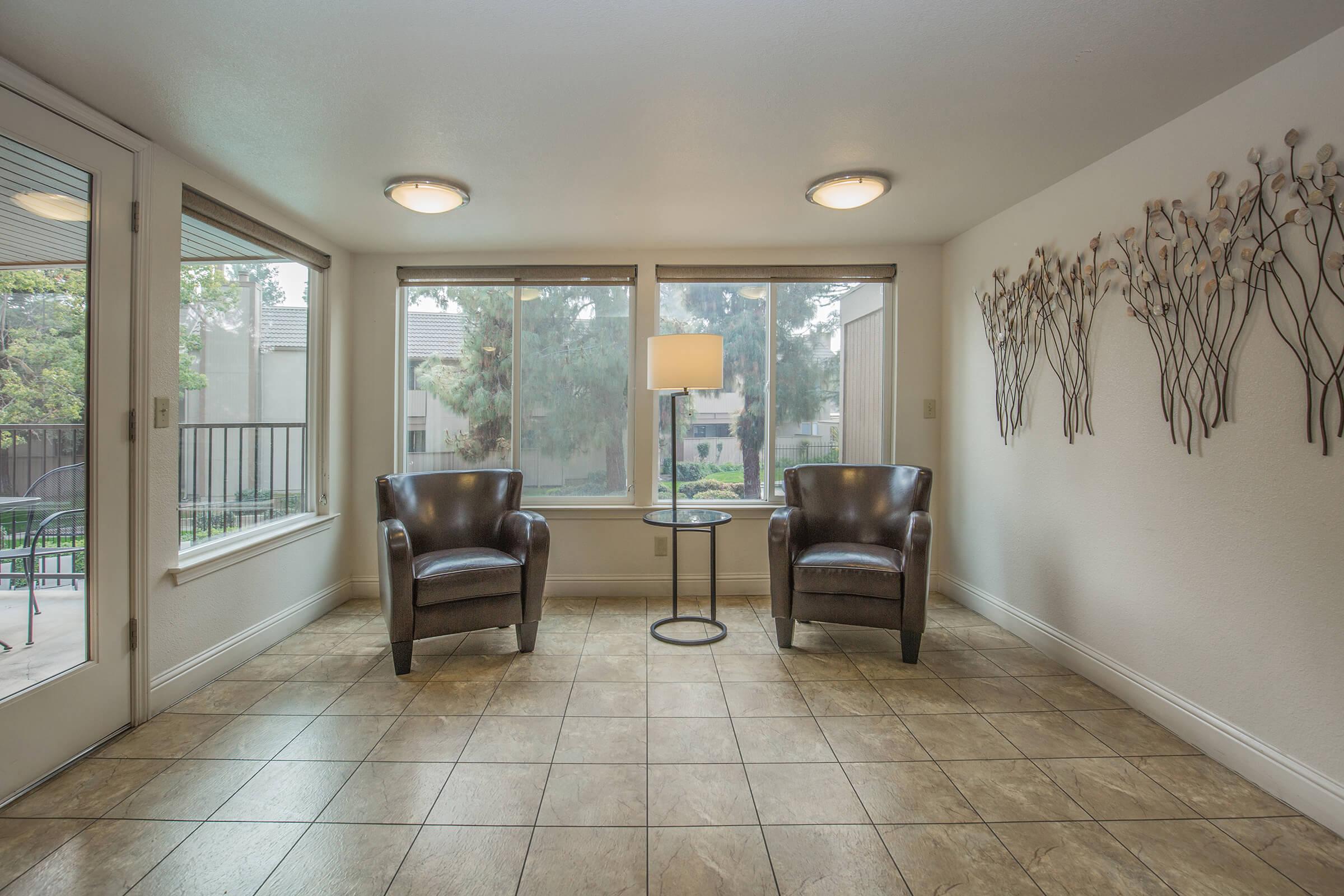 a living room filled with furniture and a large window