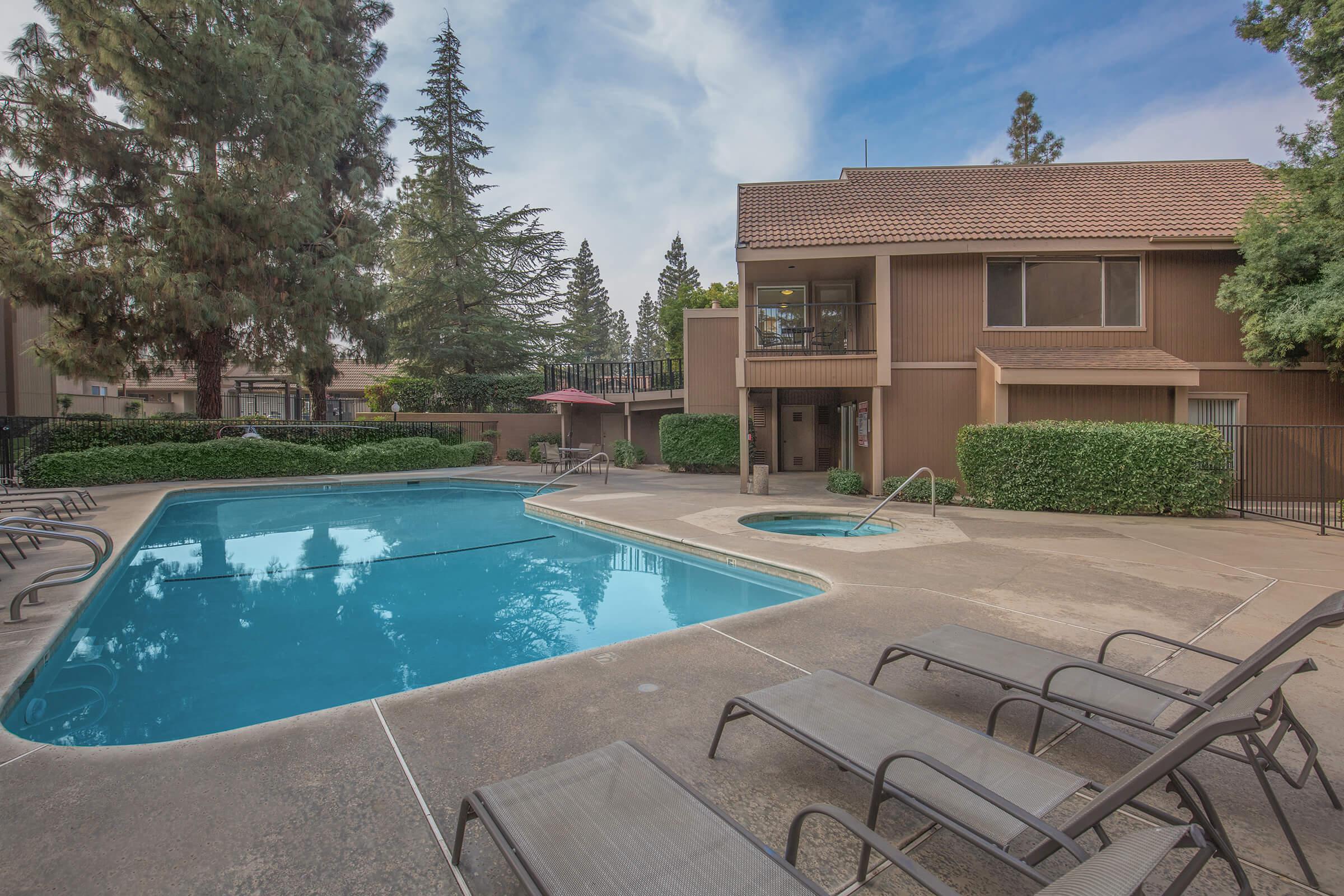 a building with a pool in front of a house