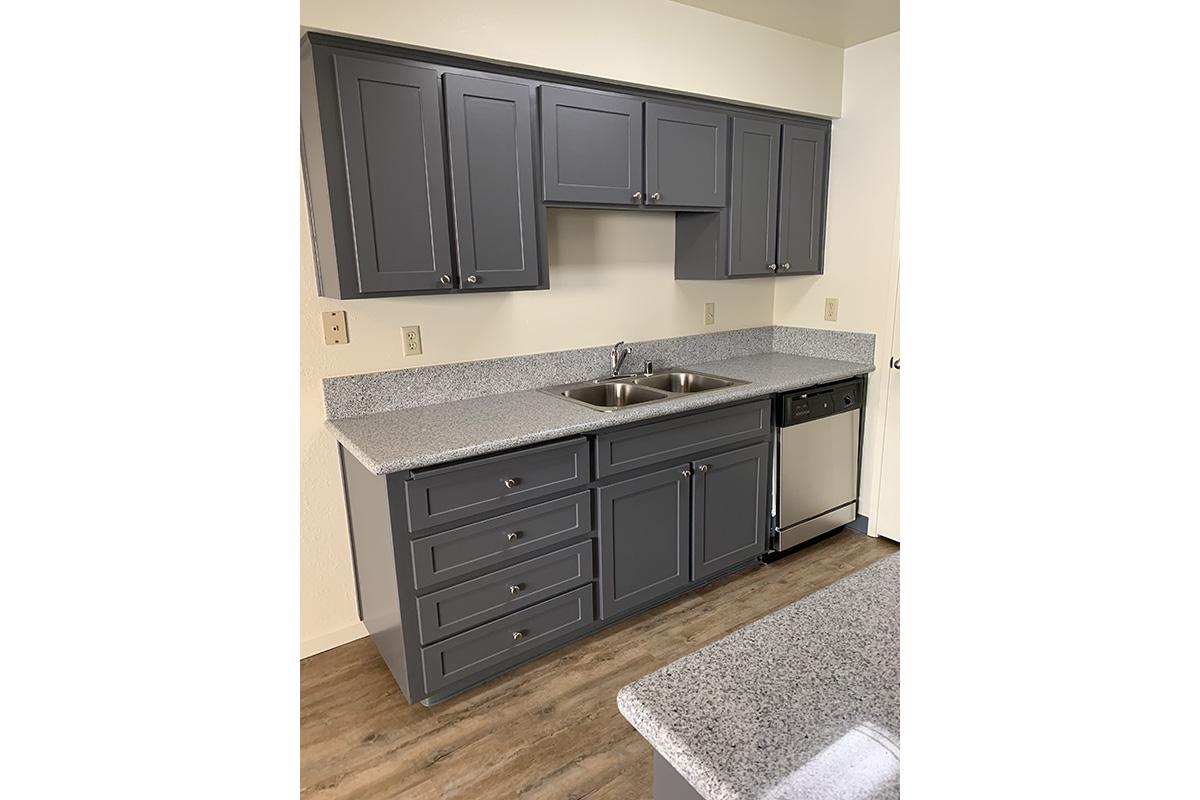 a kitchen with a sink and a mirror