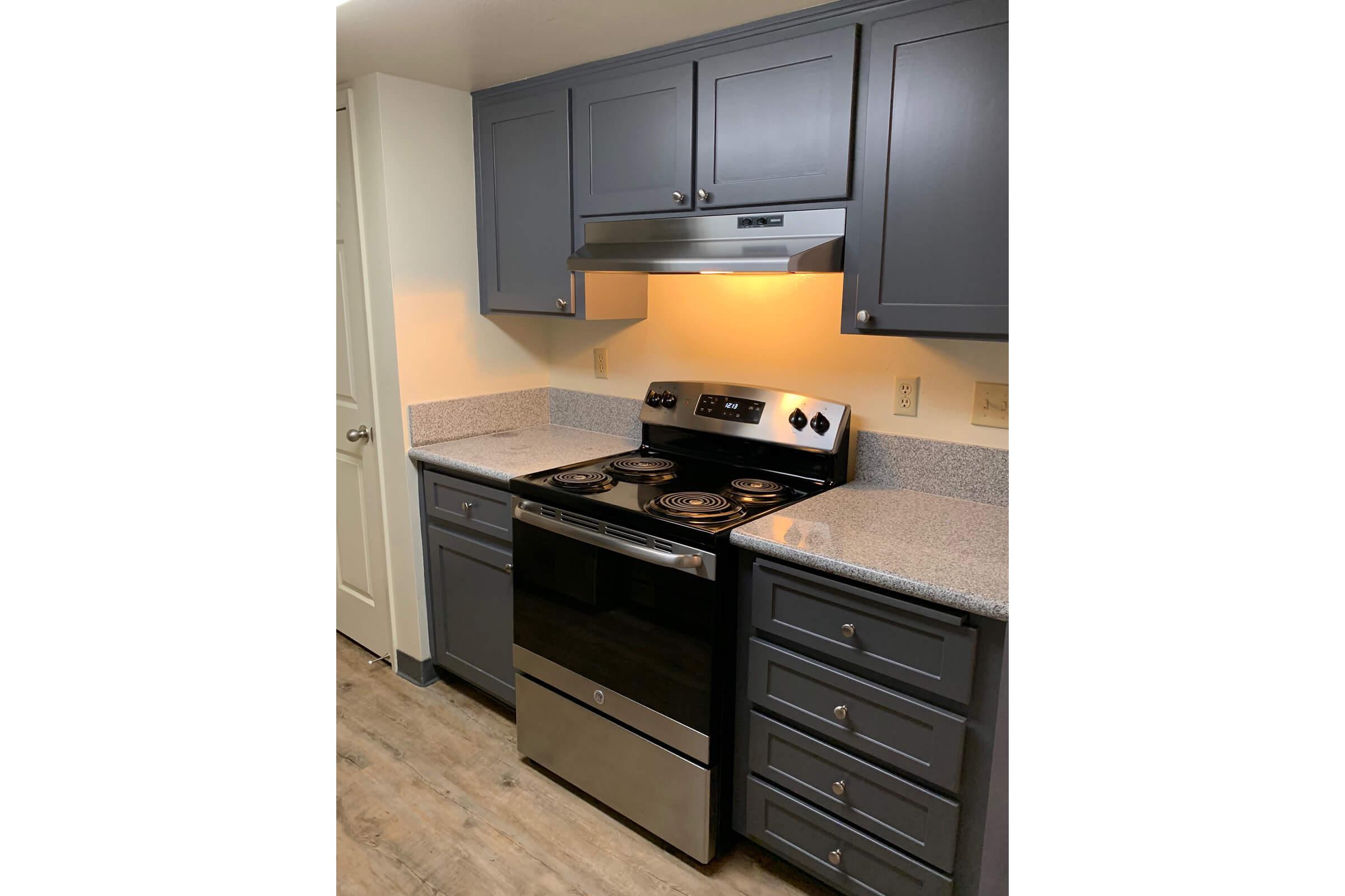 a stove top oven sitting inside of a kitchen