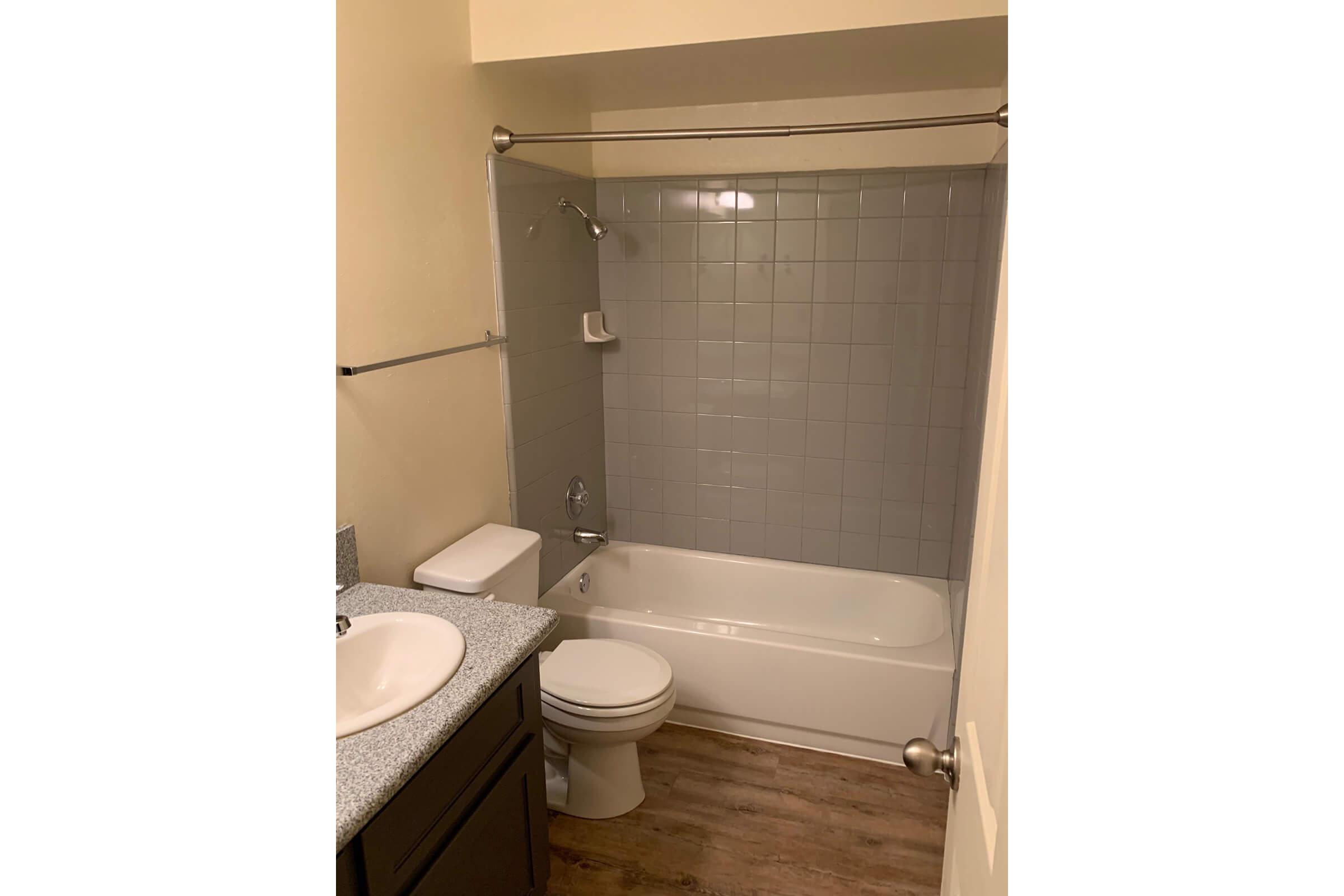 a white sink sitting next to a shower