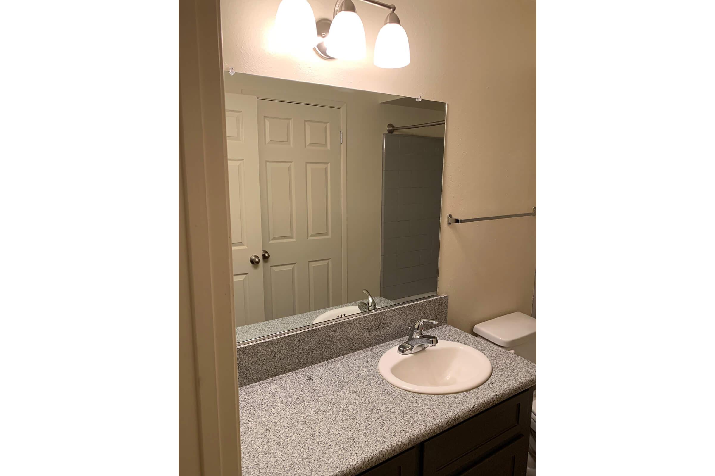 a white sink and a mirror