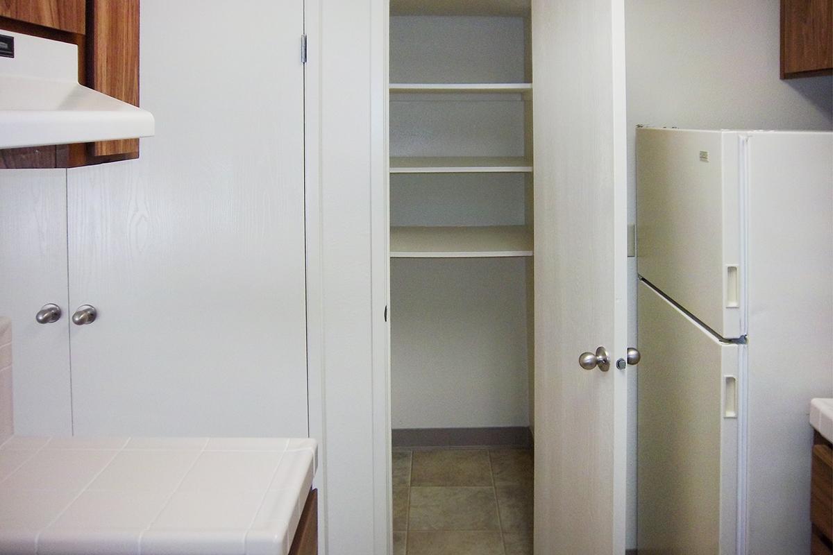 a white sink sitting next to a shower