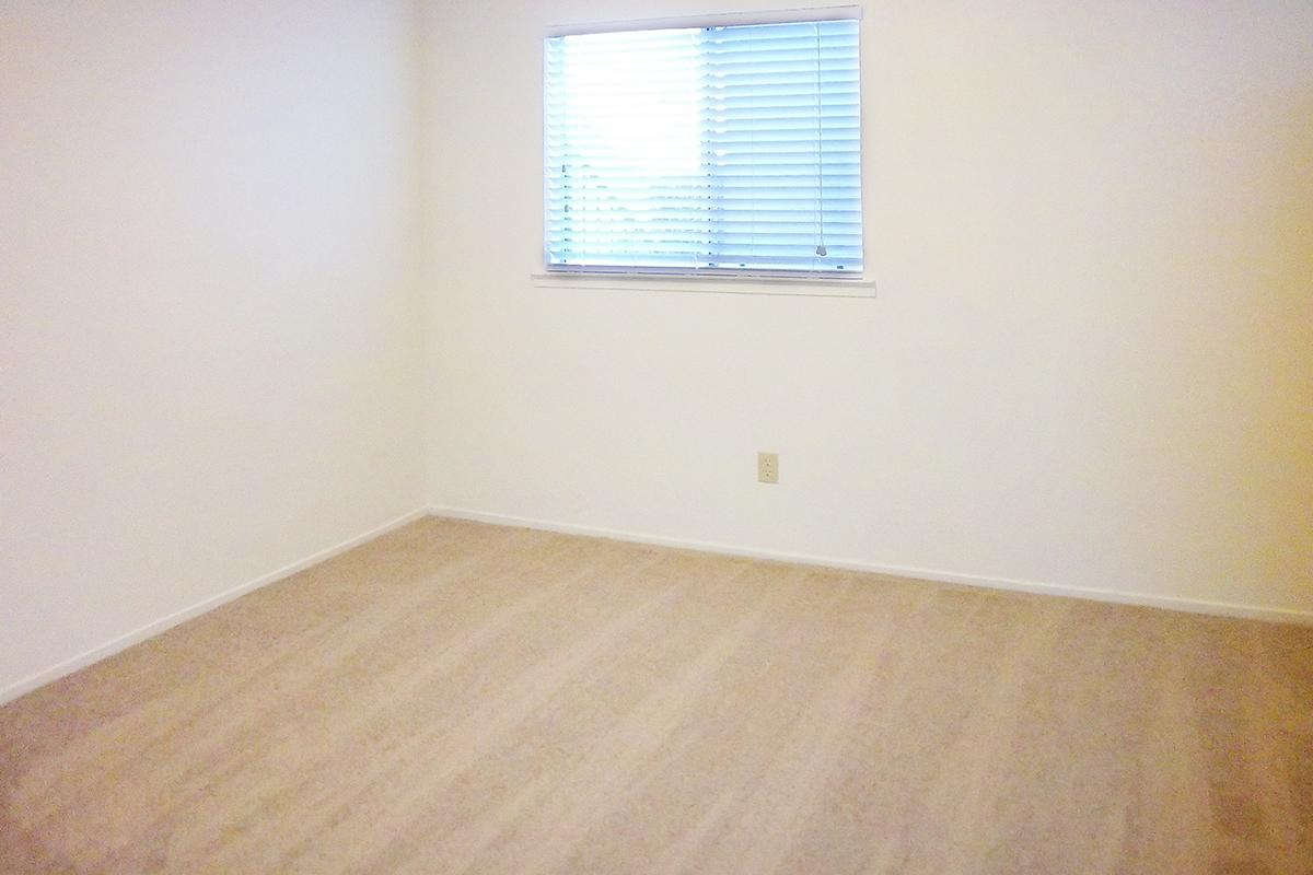 a bedroom with a wooden floor