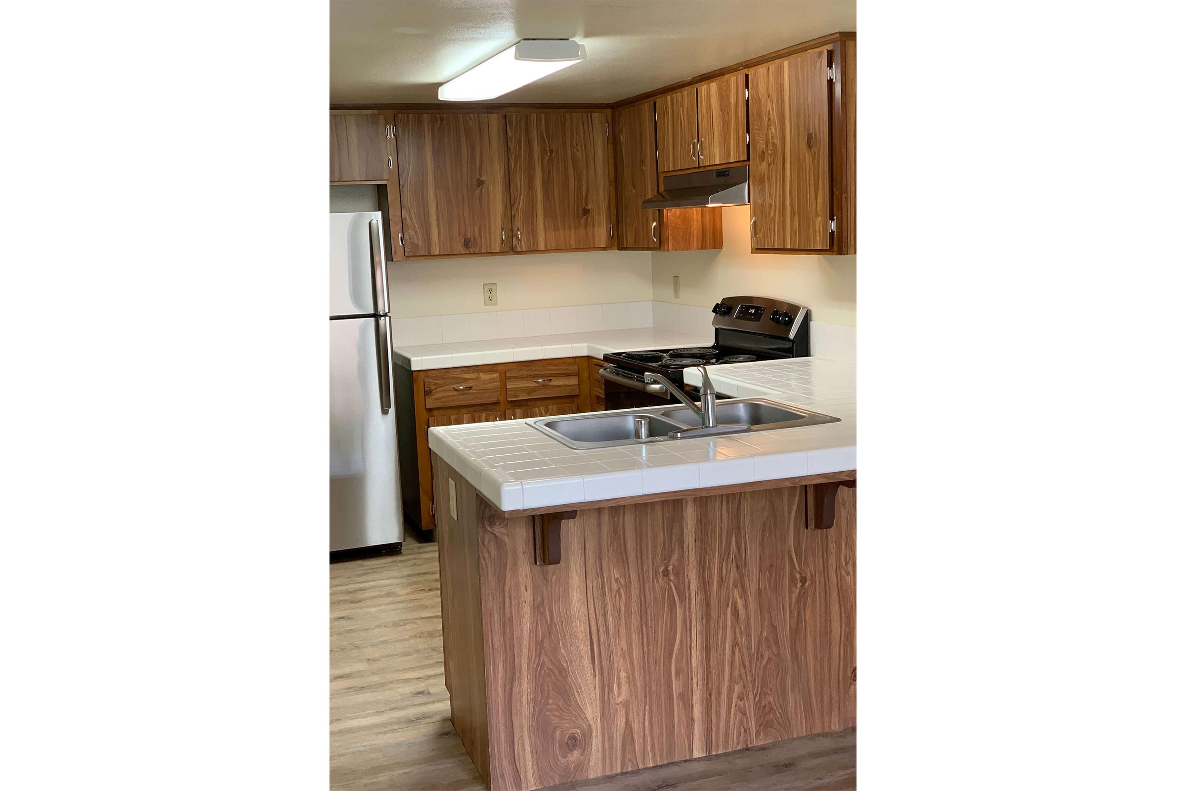 a kitchen with wooden cabinets