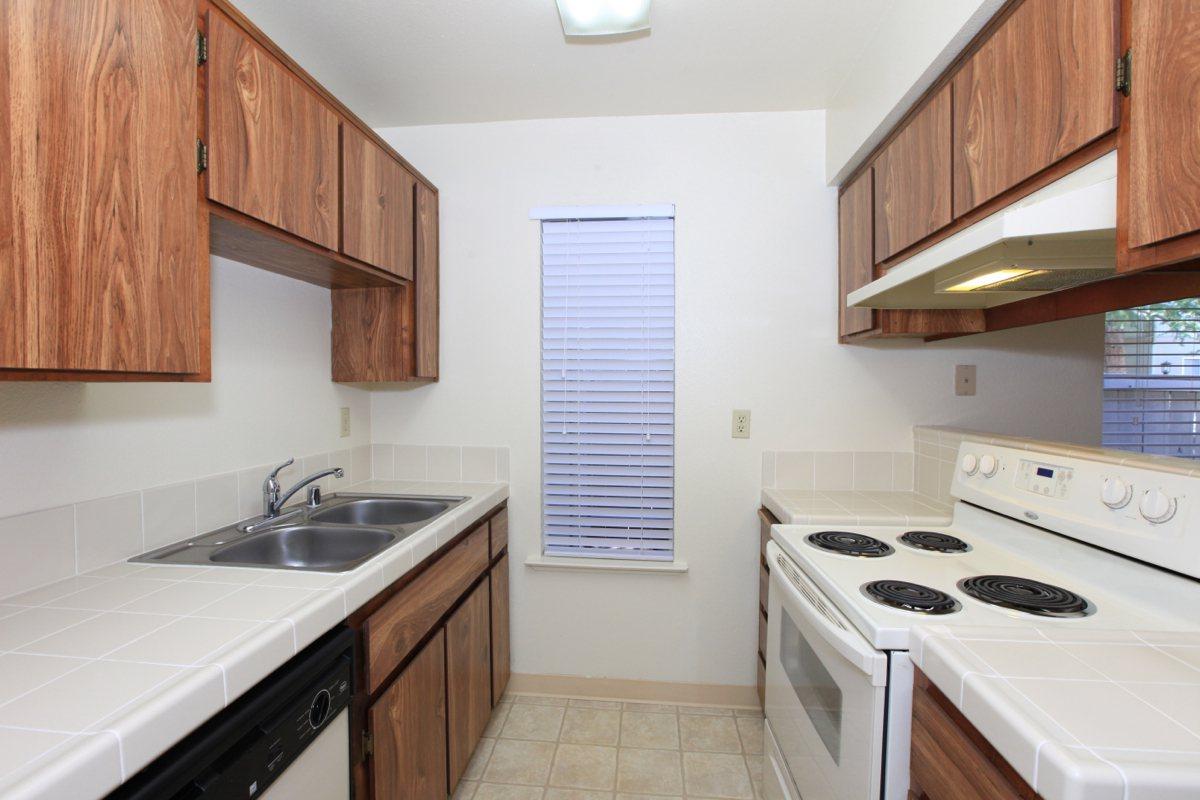 a kitchen with a stove sink and refrigerator