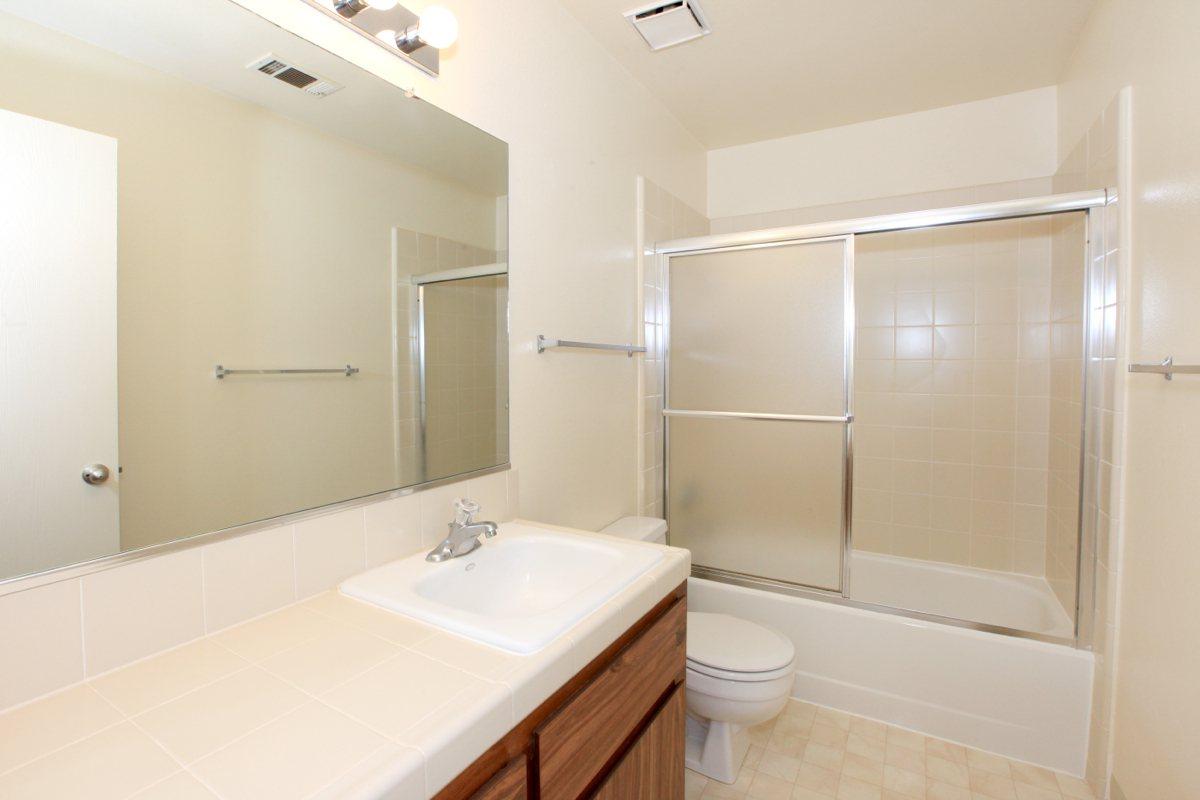 a large white tub sitting next to a sink