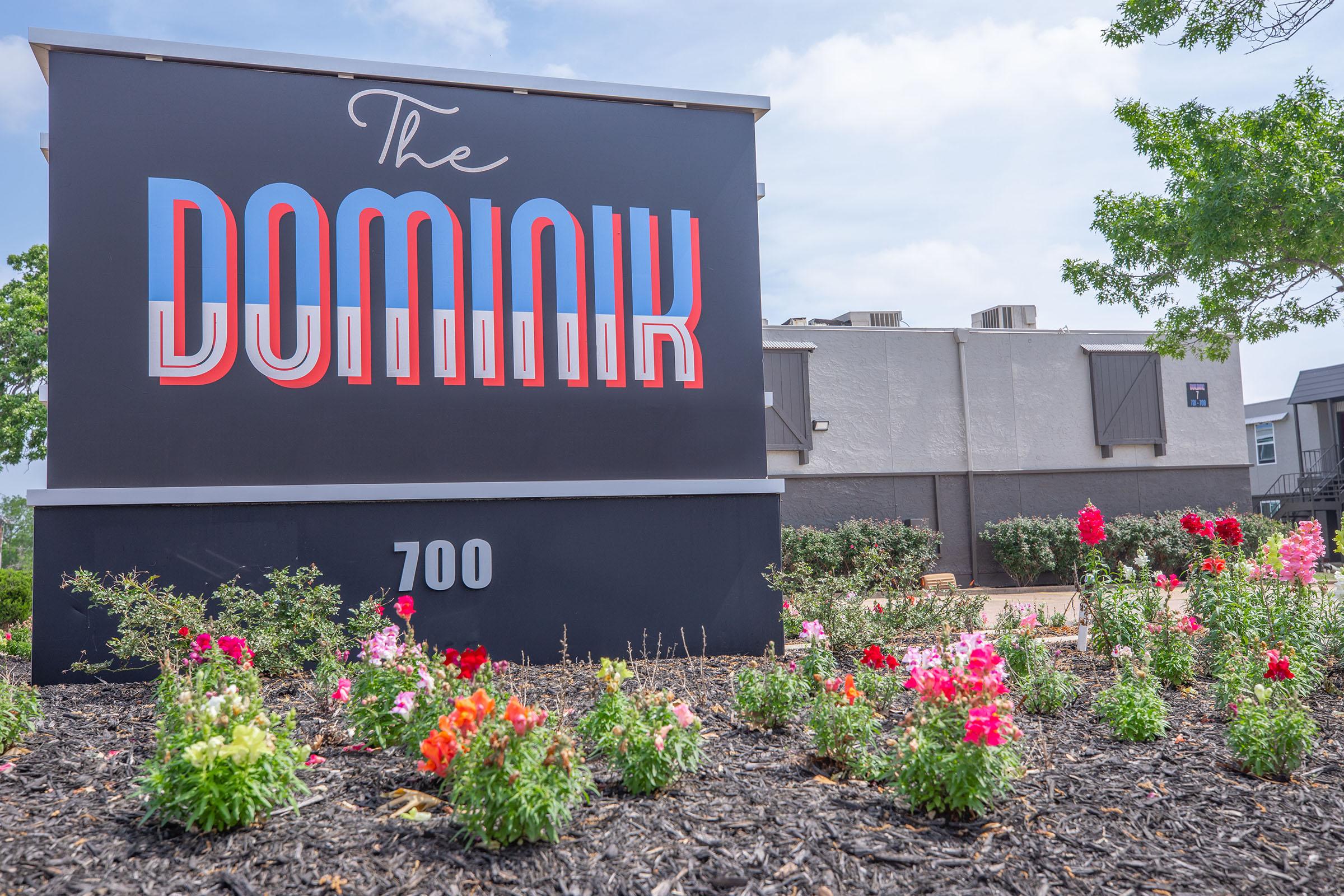 a colorful flower garden in front of a building