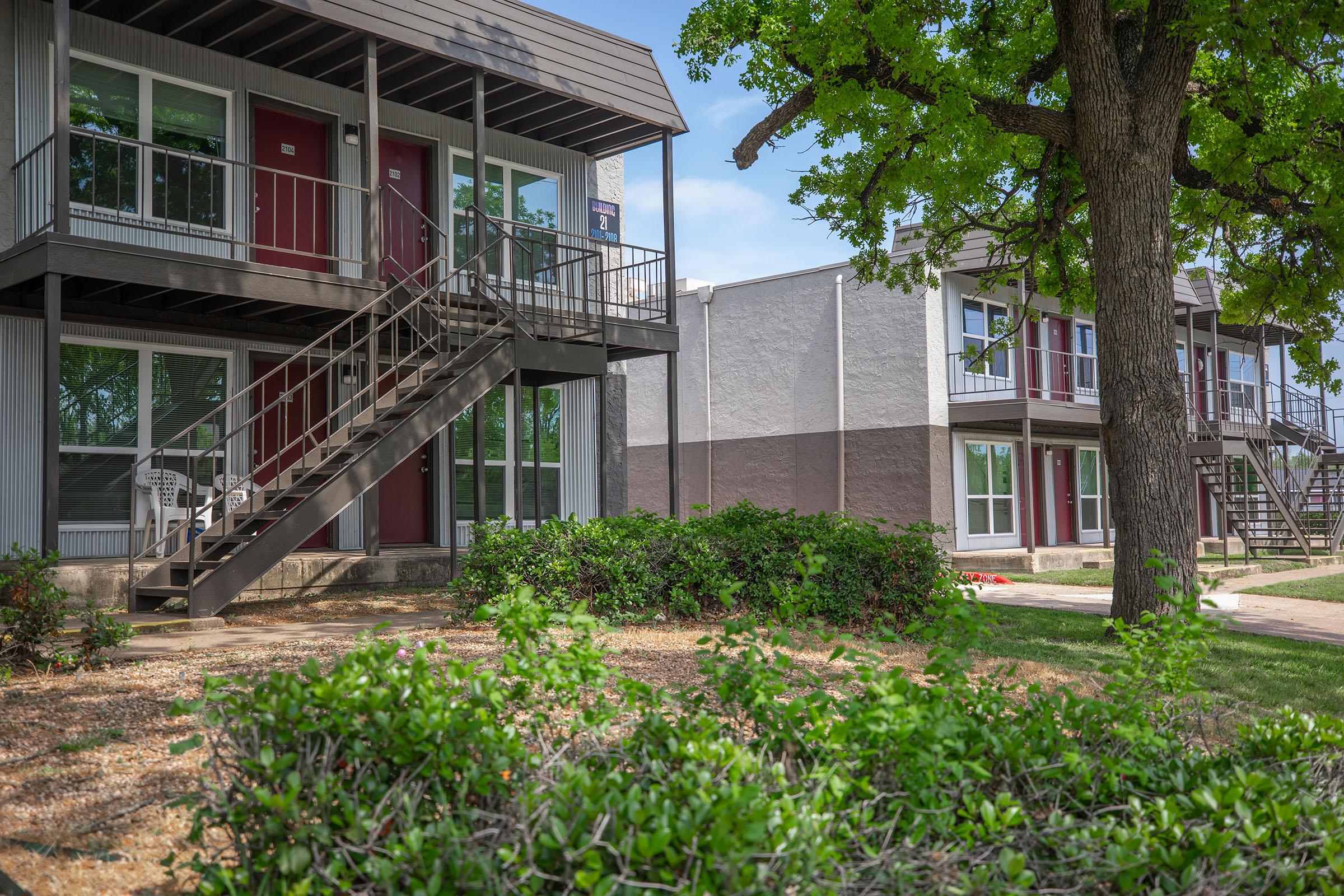 a house with bushes in front of a building