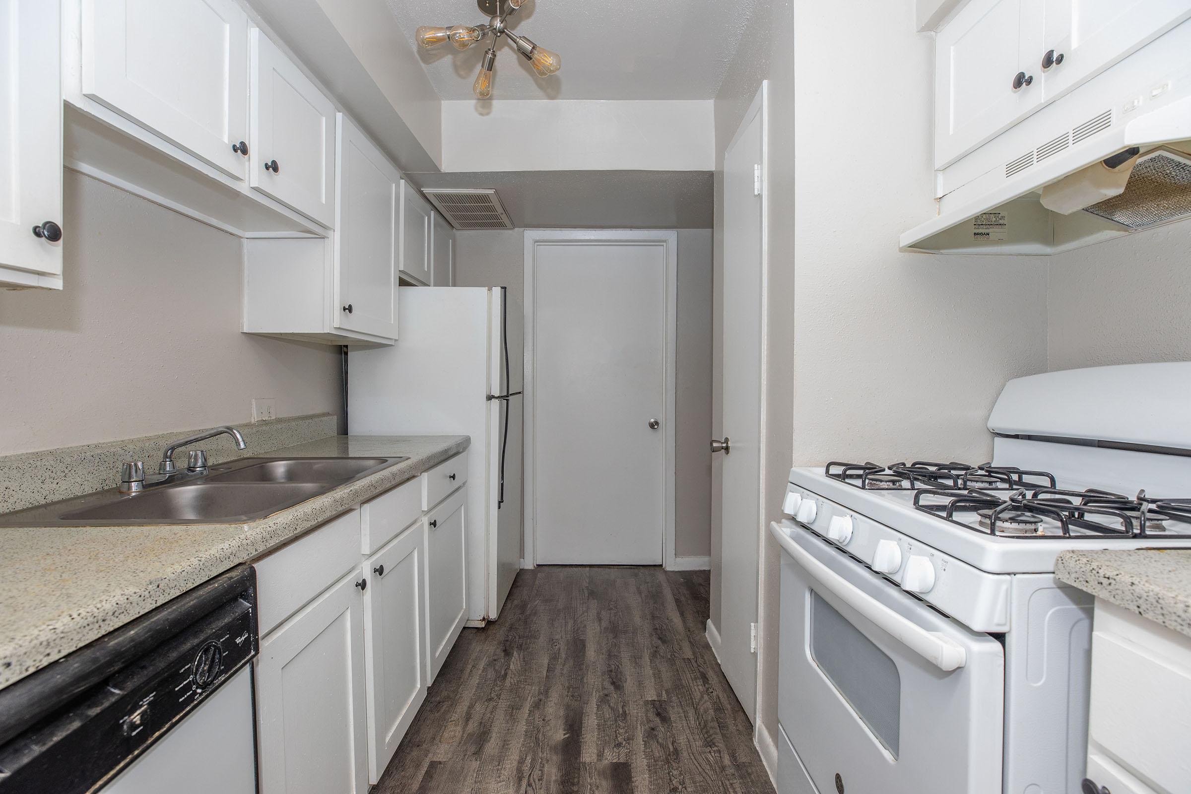 a kitchen with a stove and a sink