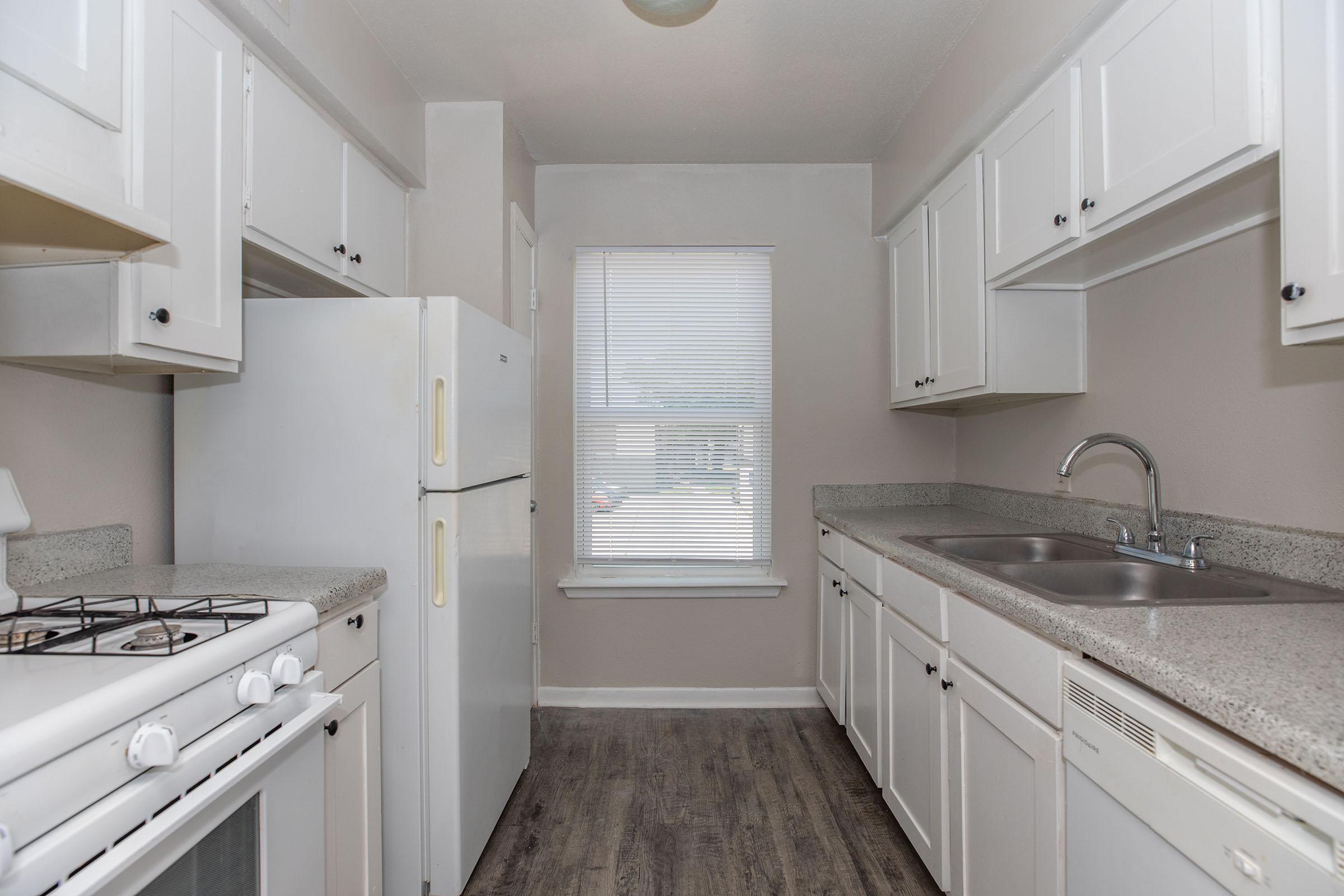 a kitchen with a sink and a window