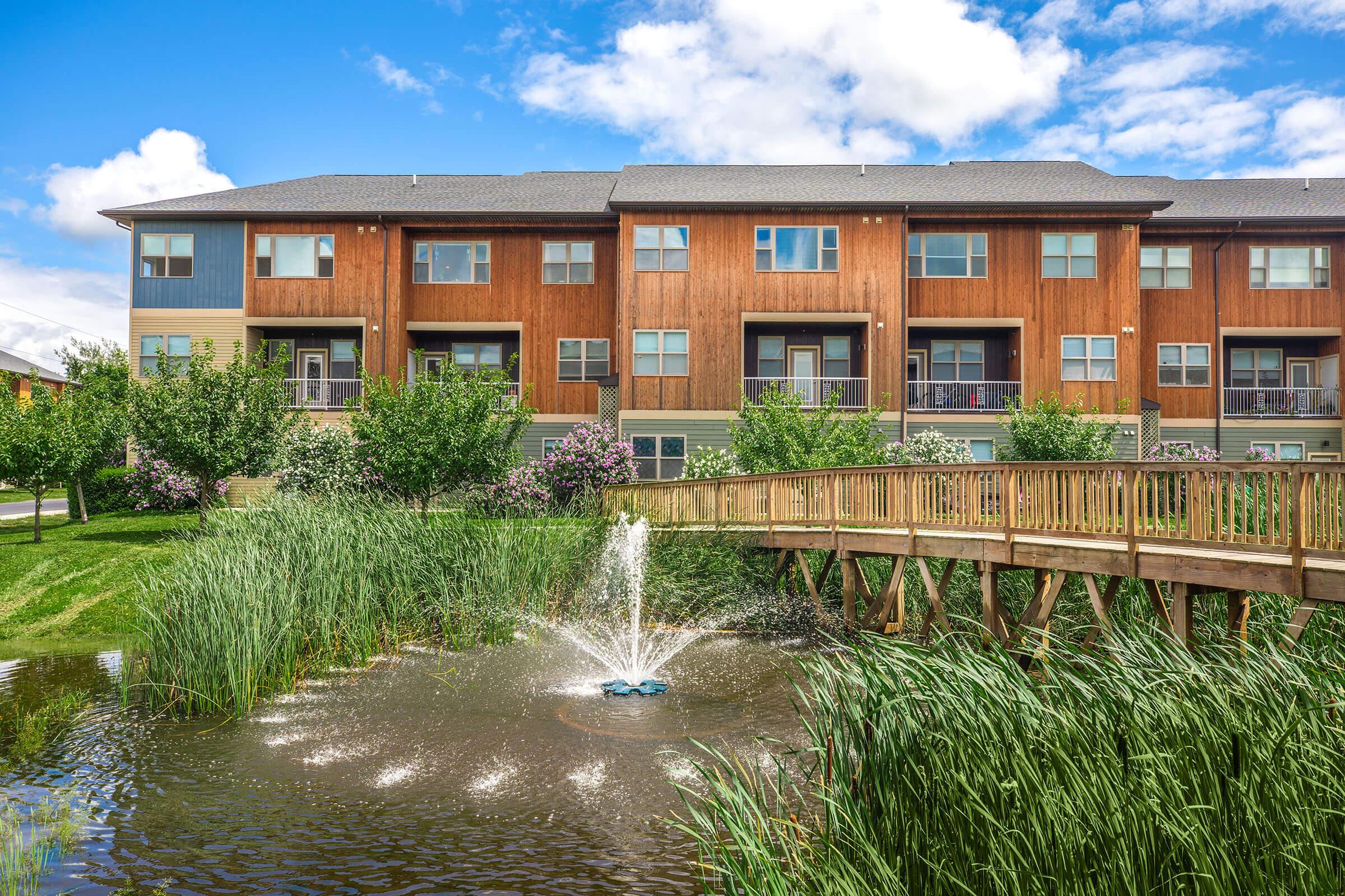 a garden with water in front of a building