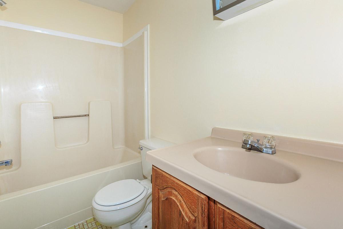 a white tub sitting next to a sink