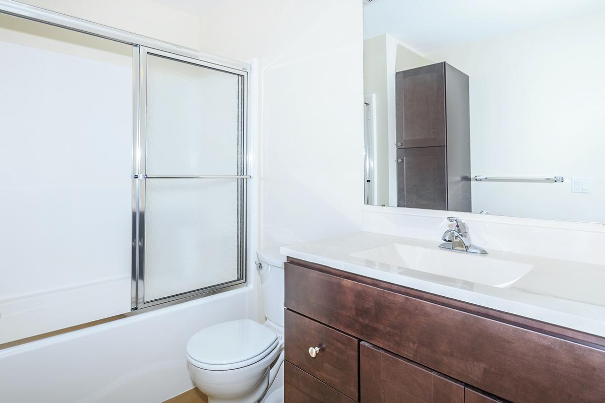 a large white tub next to a shower