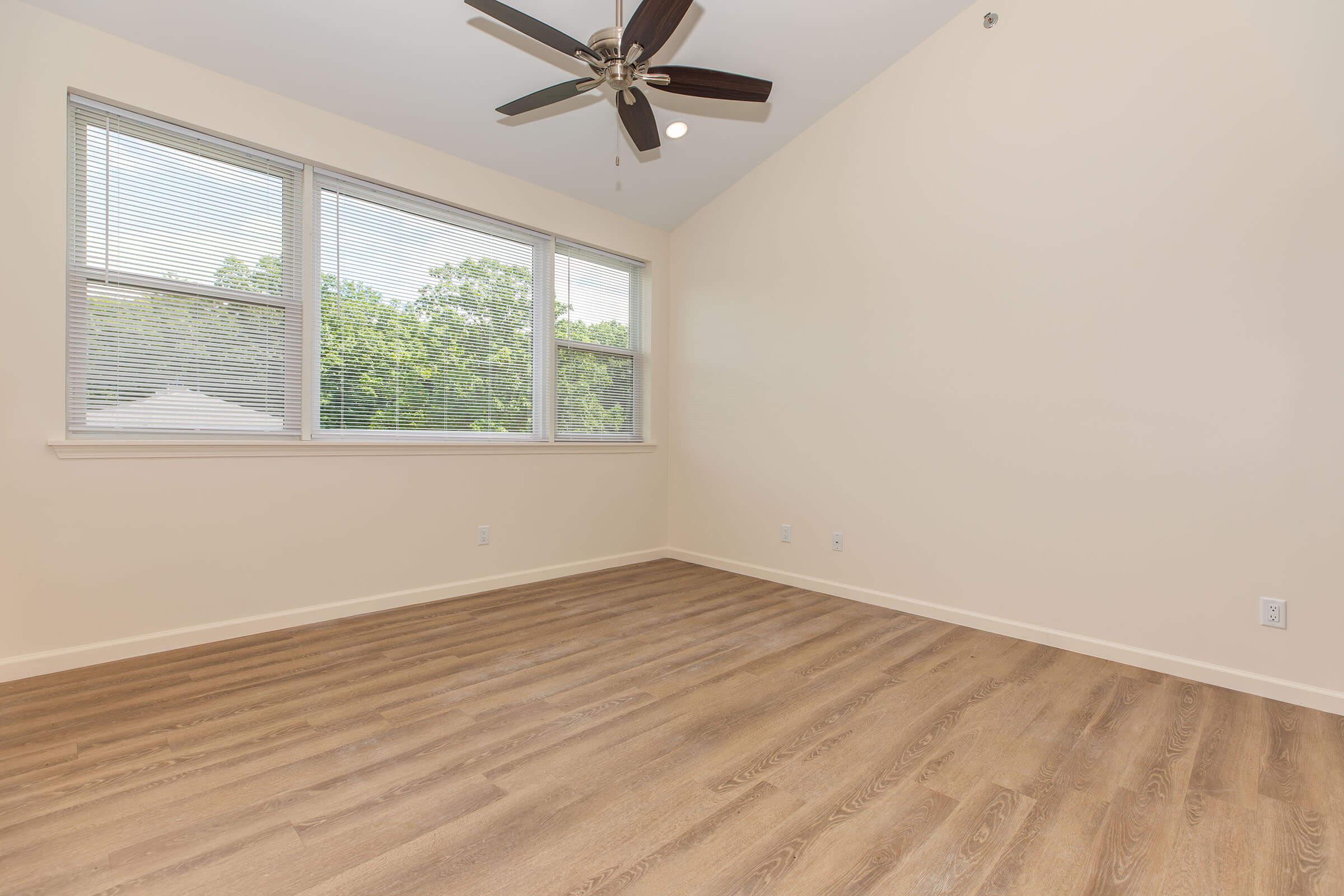 a bedroom with a wooden floor