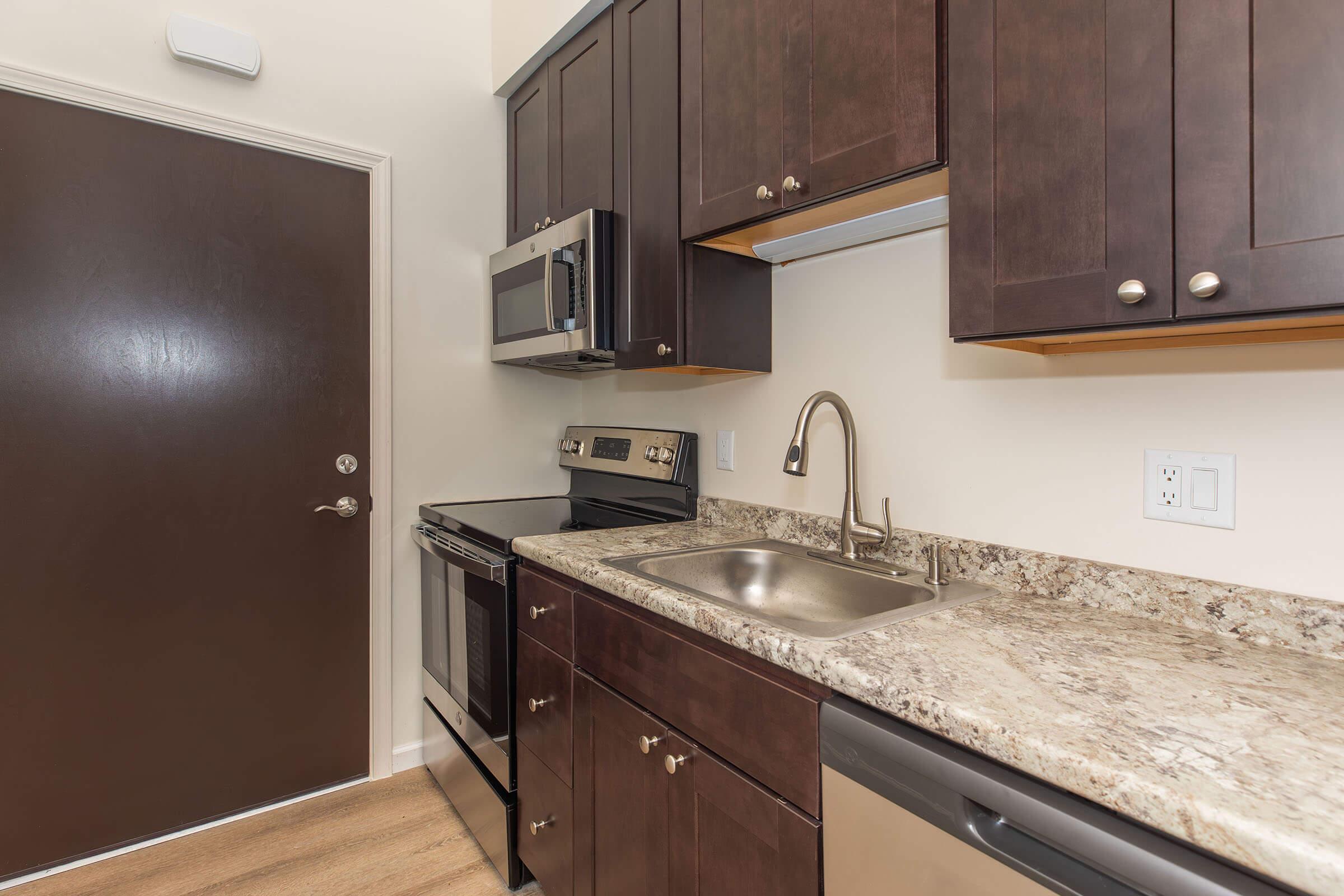 a kitchen with a sink and a microwave