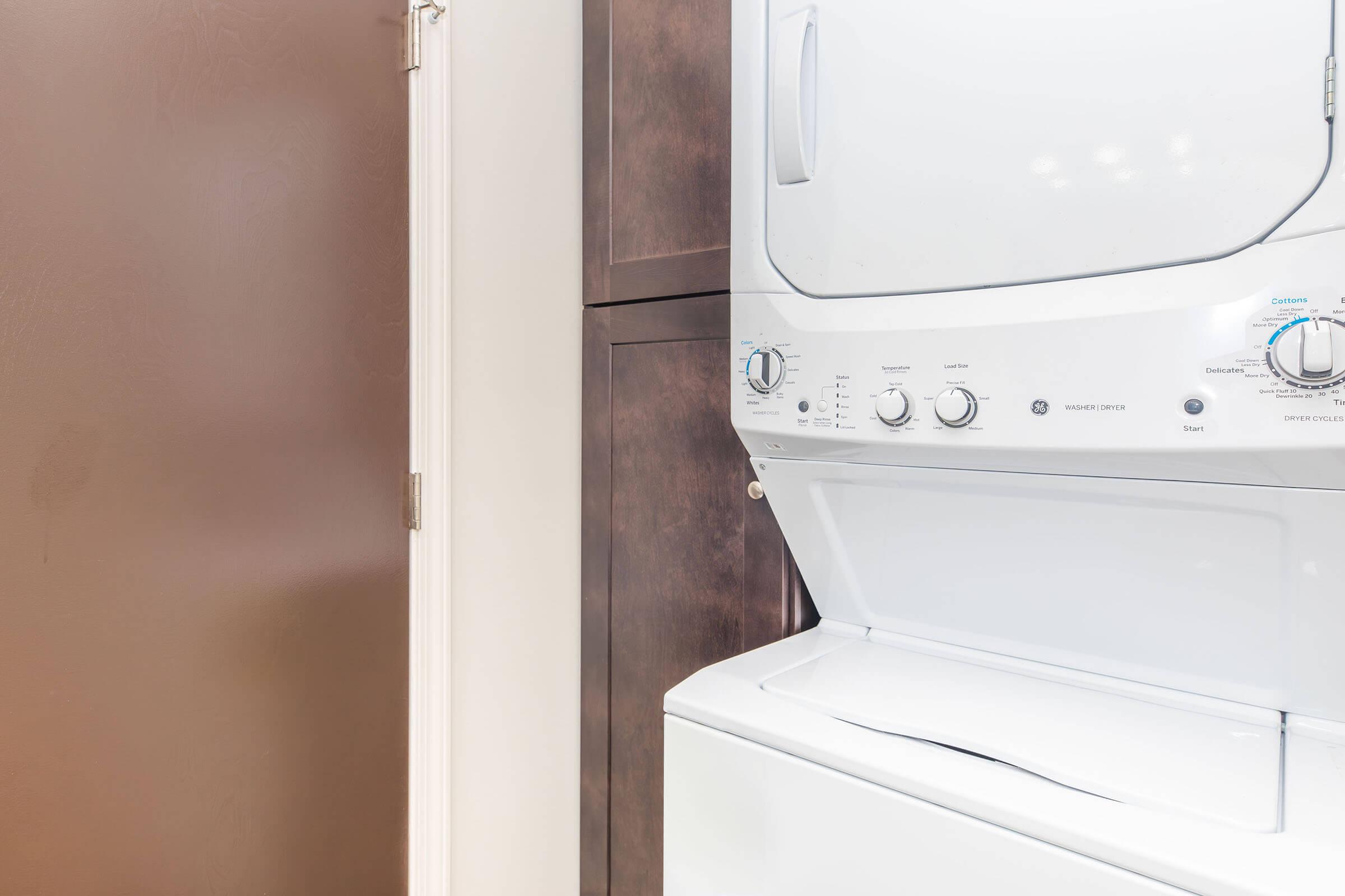 a microwave oven sitting on top of a refrigerator