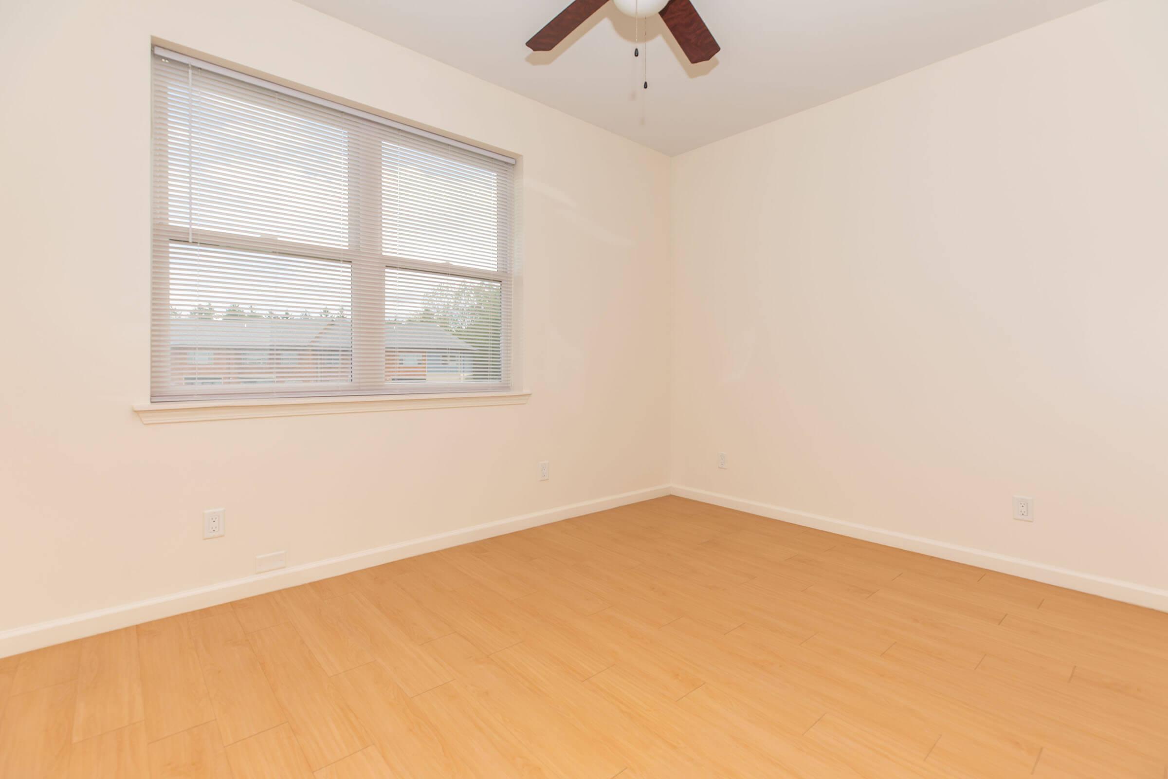 a close up of a hard wood floor next to a window