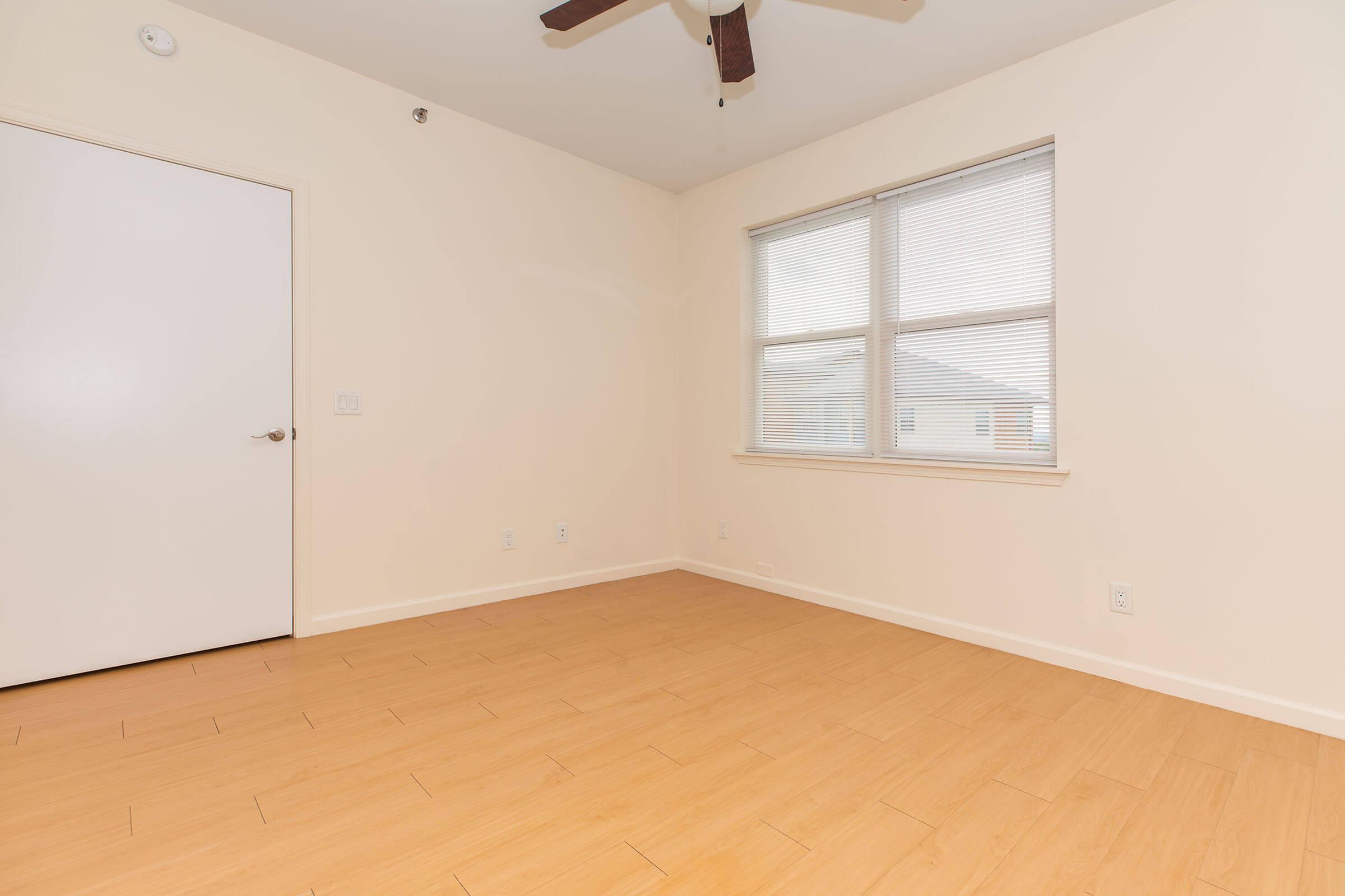 a bedroom with a wooden floor