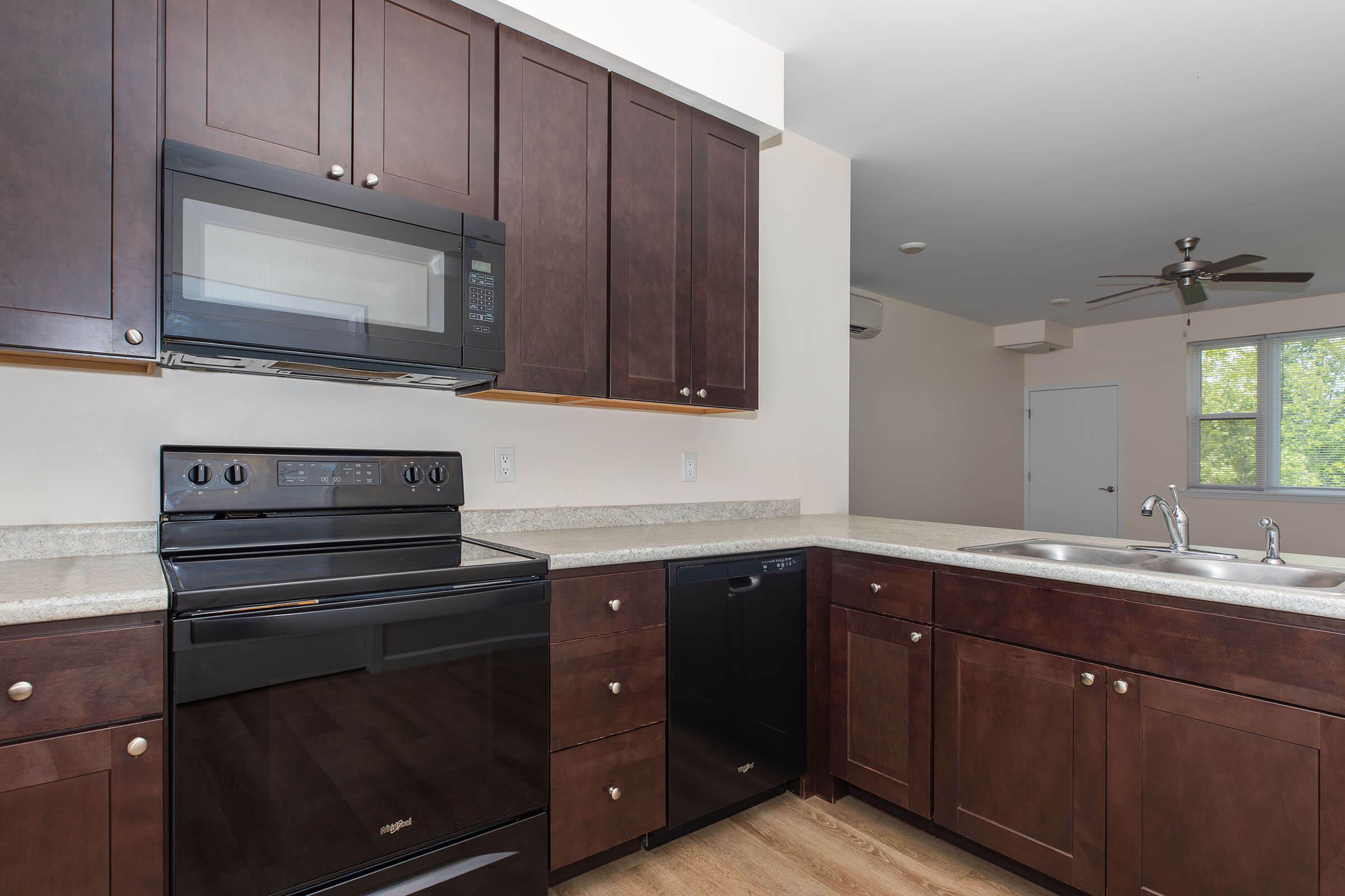 a kitchen with wooden cabinets and an oven