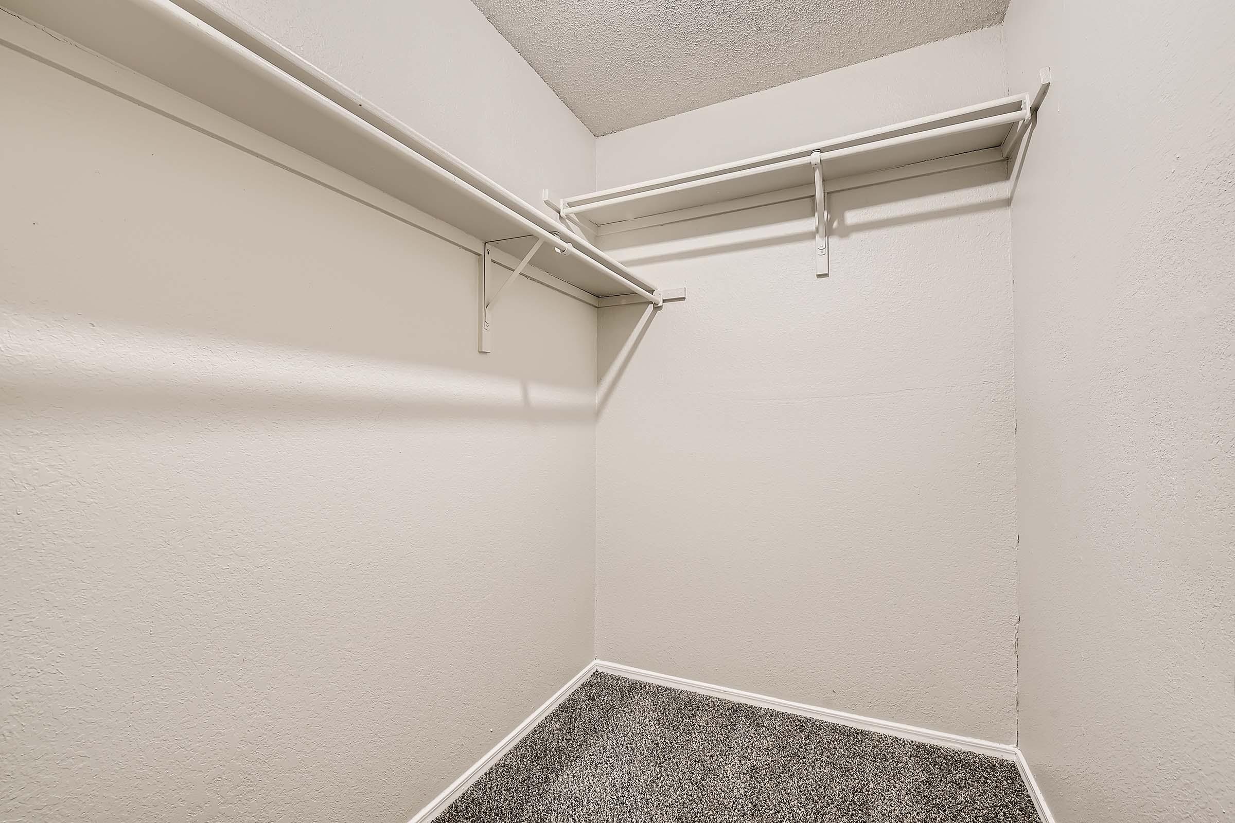 Closeup of an empty carpeted closet at Rise Bedford Lake apartments in Bedford, TX