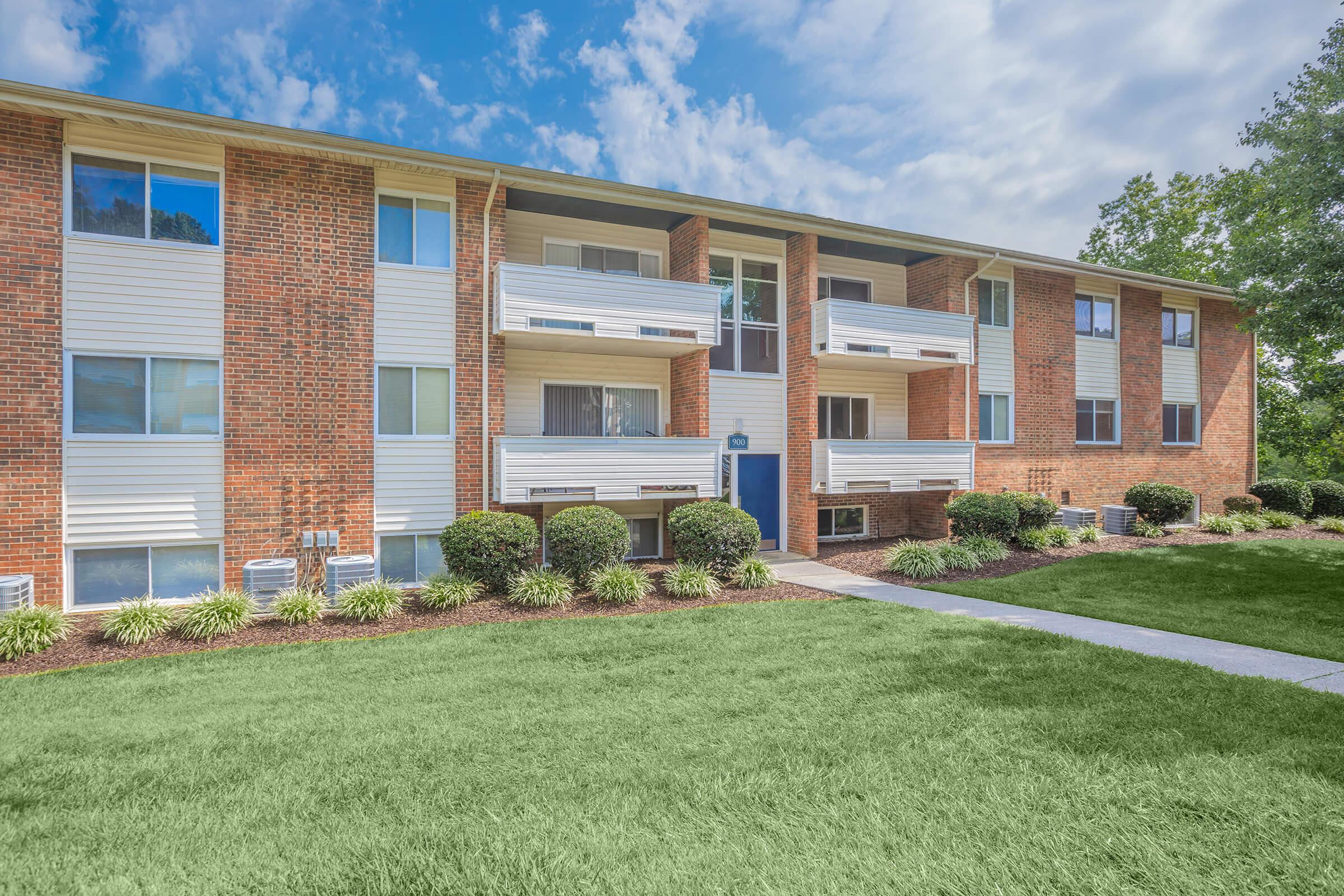 a large lawn in front of a brick building