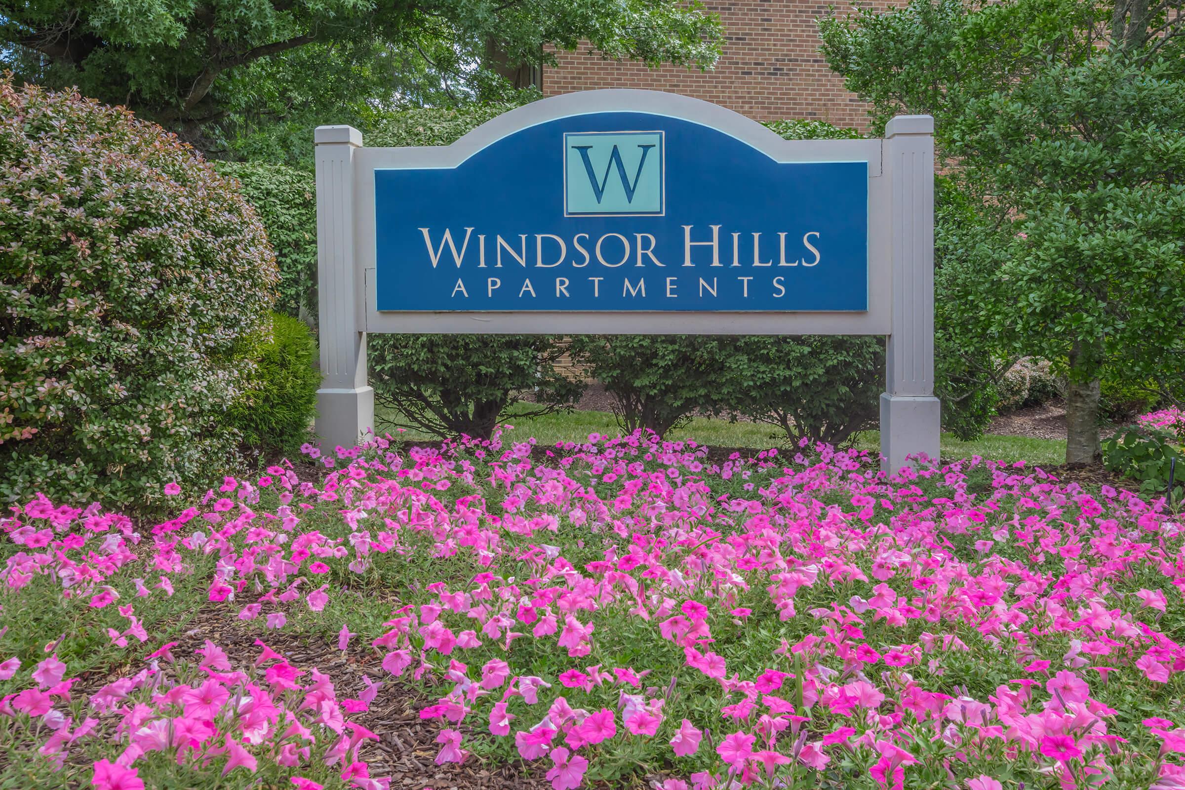 a sign in front of a flower