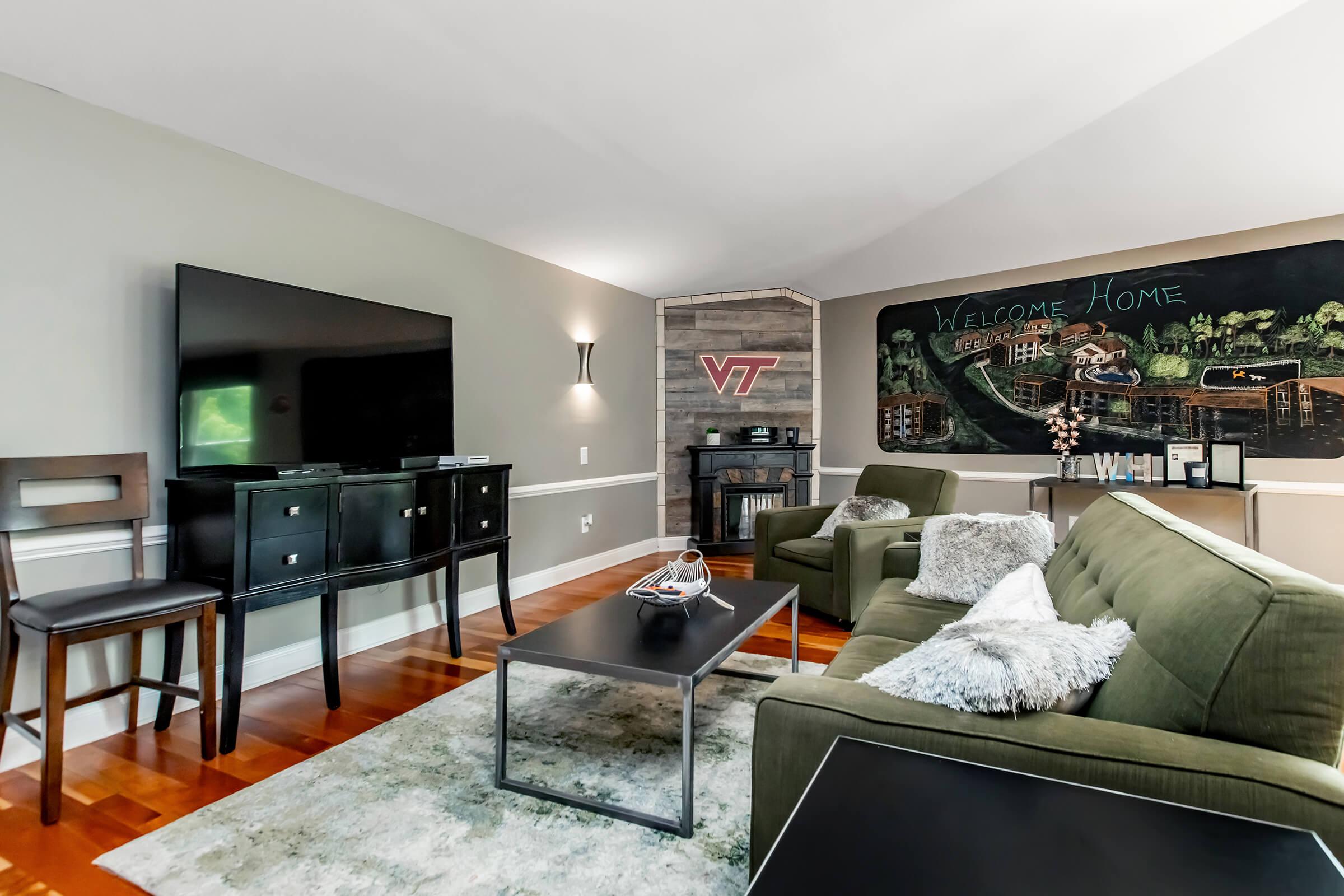 a living room filled with furniture and a flat screen tv