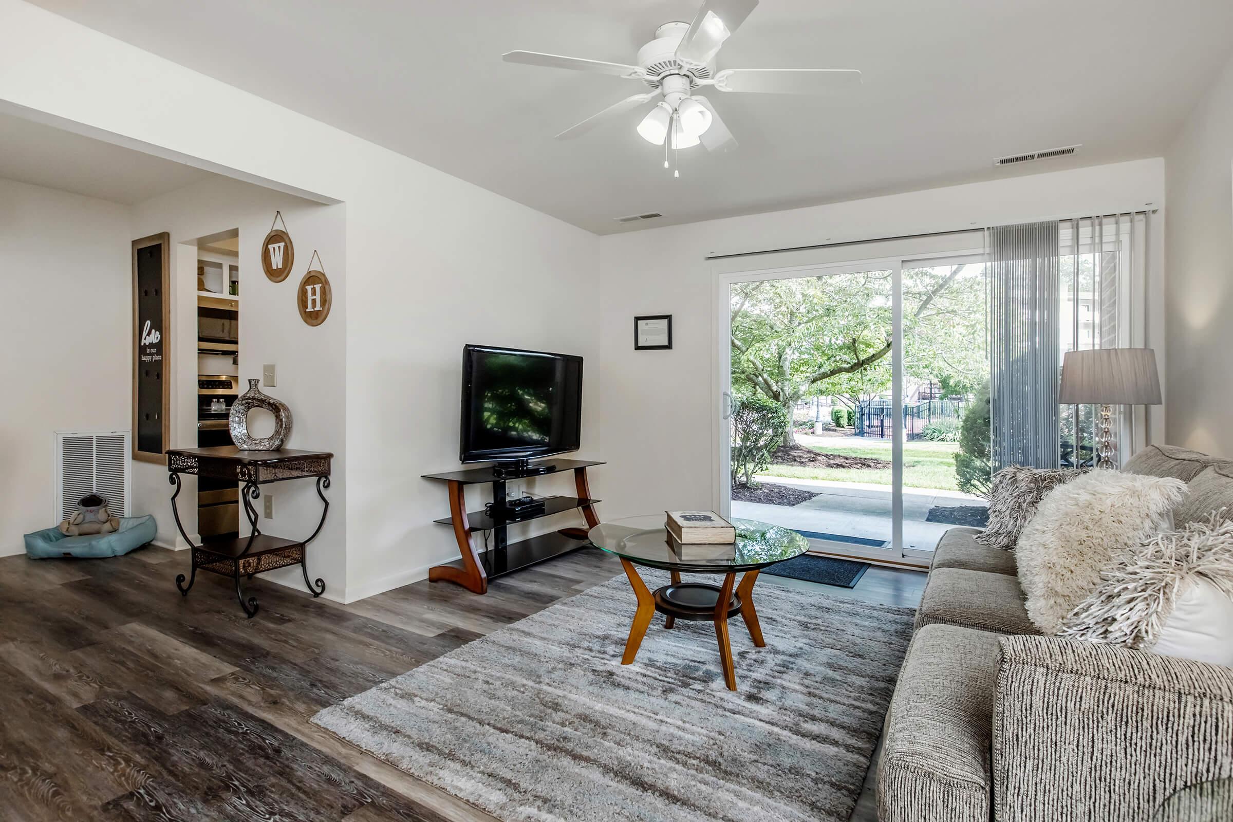 a living room filled with furniture and a large window