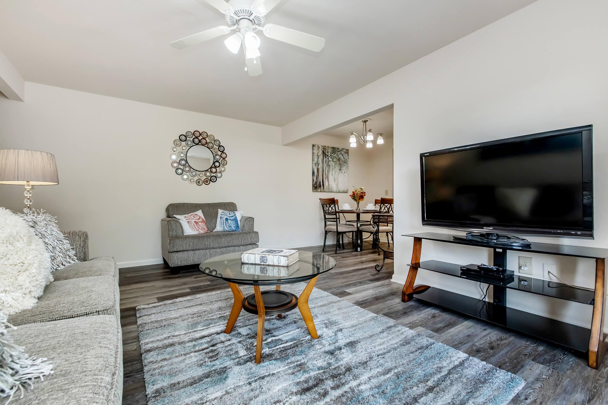 a living room filled with furniture and a flat screen tv