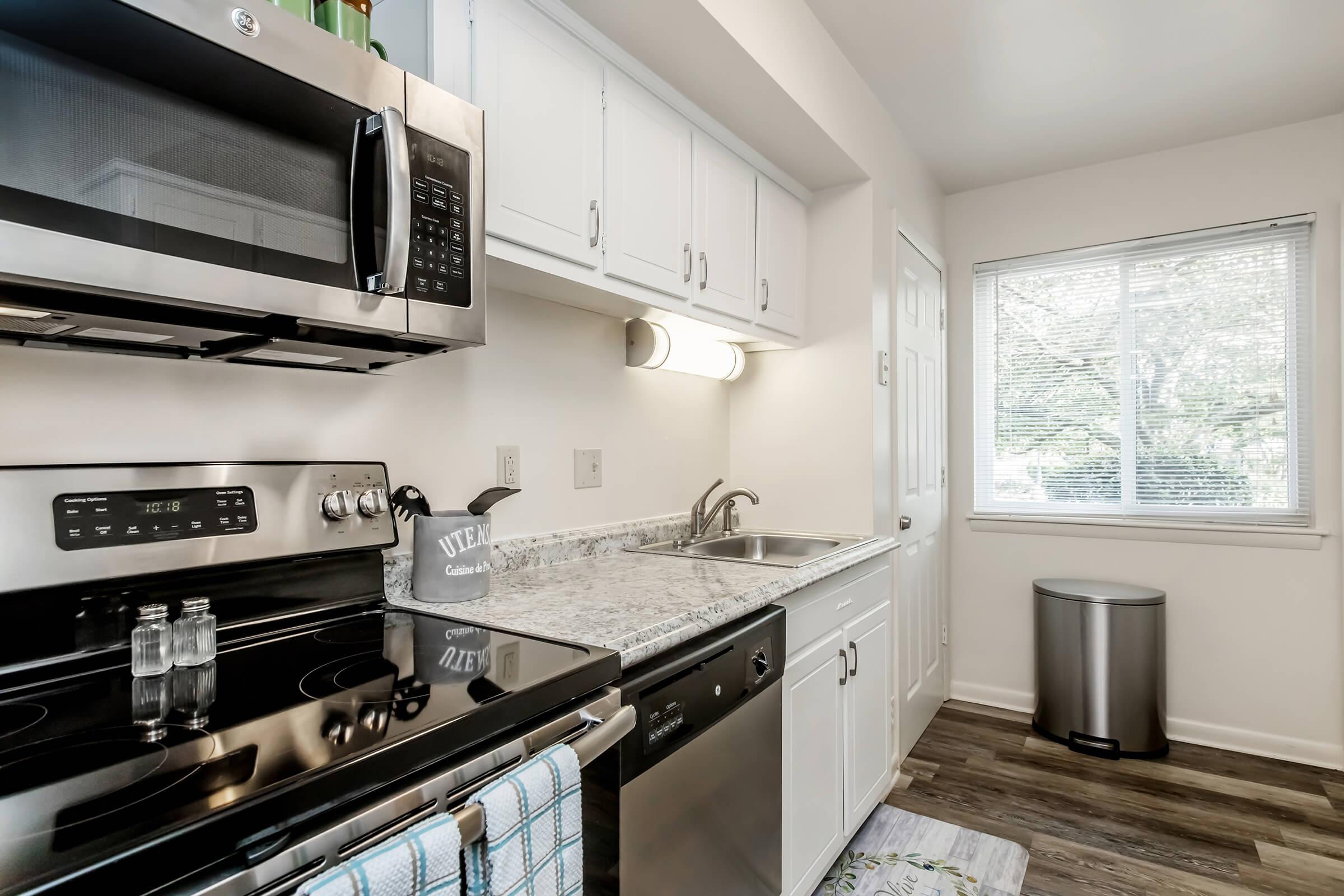 a kitchen with a stove top oven sitting next to a window