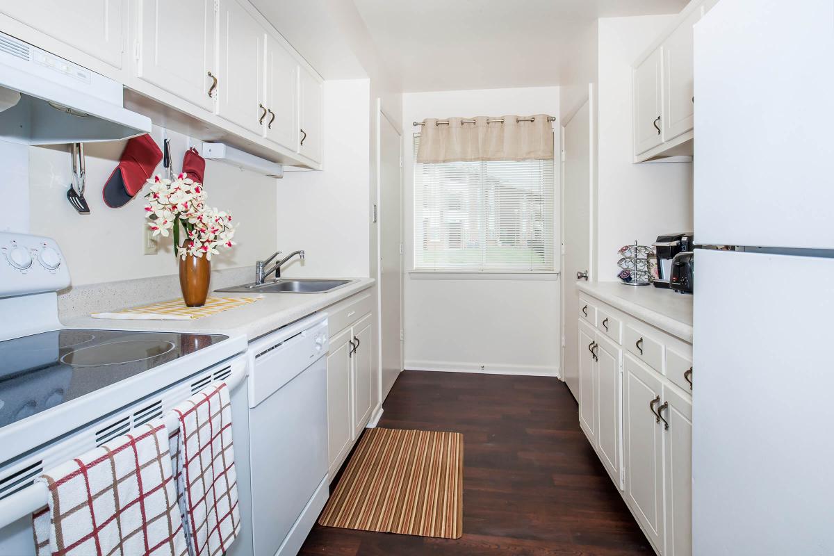 a kitchen with white appliances and wooden cabinets