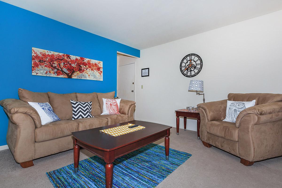 a living room filled with furniture and decor