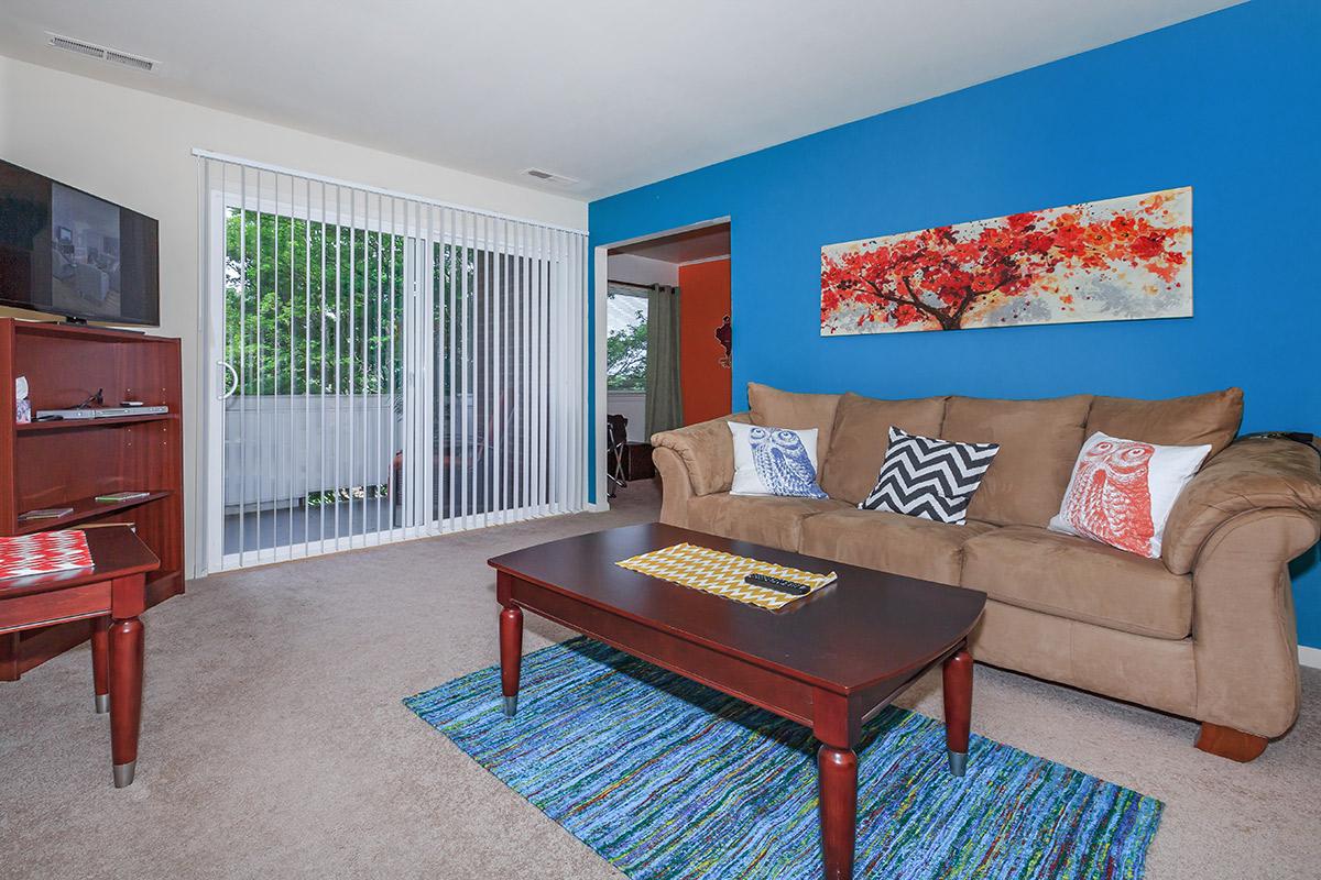 a living room filled with furniture and a flat screen tv