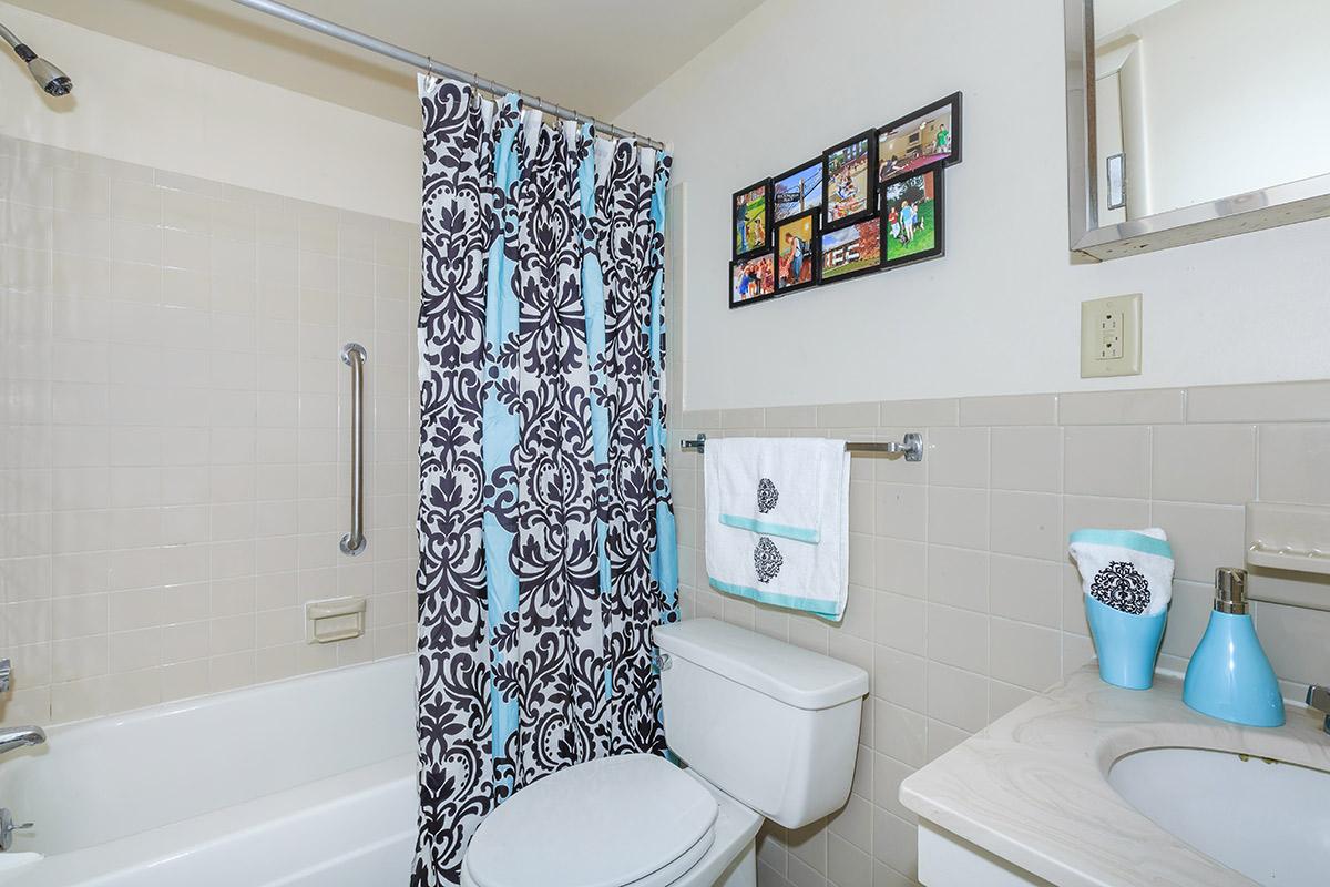 a white tub sitting next to a sink