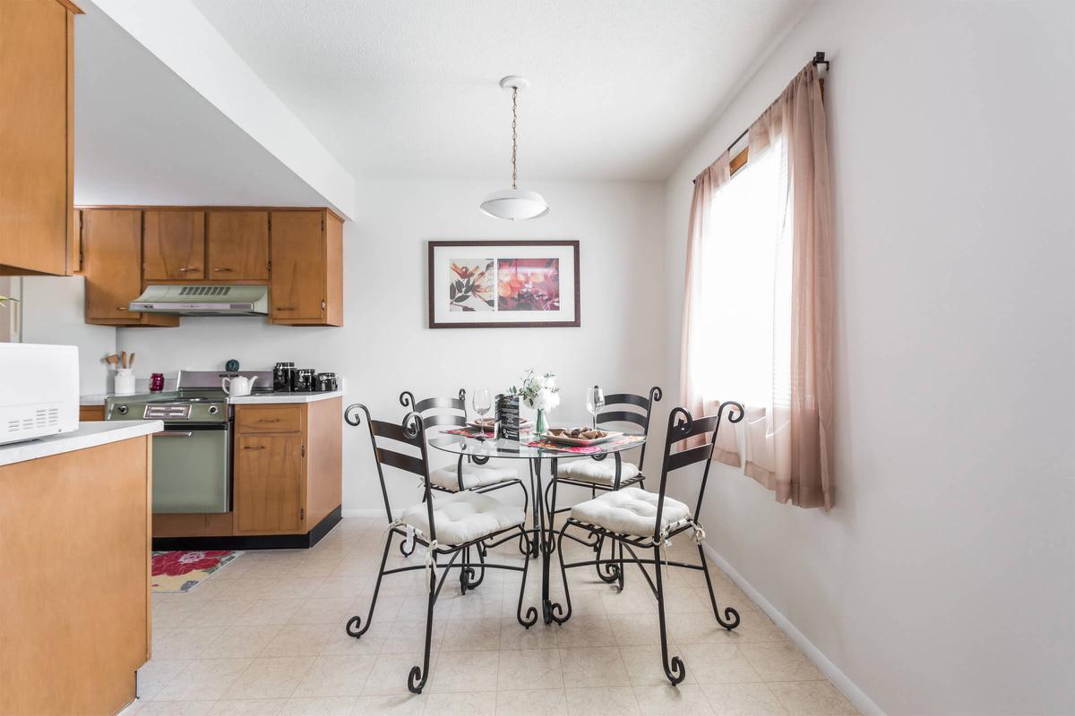 a kitchen area with wooden wheels in a room