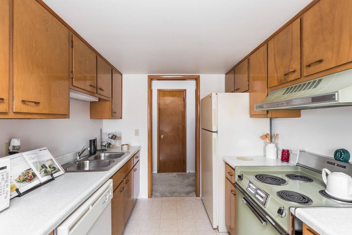 a kitchen with a stove sink and refrigerator