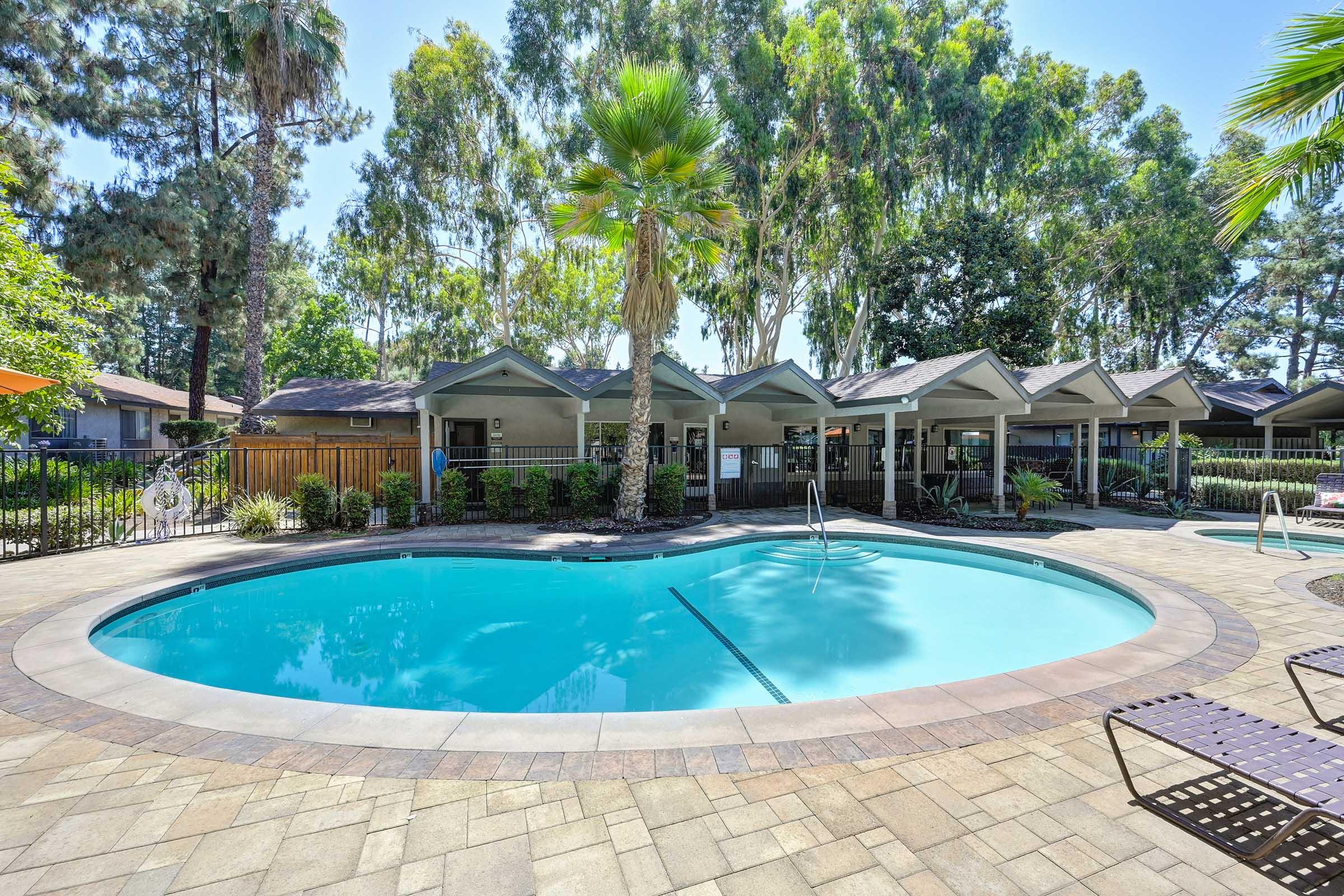 a swimming pool with lounge chairs