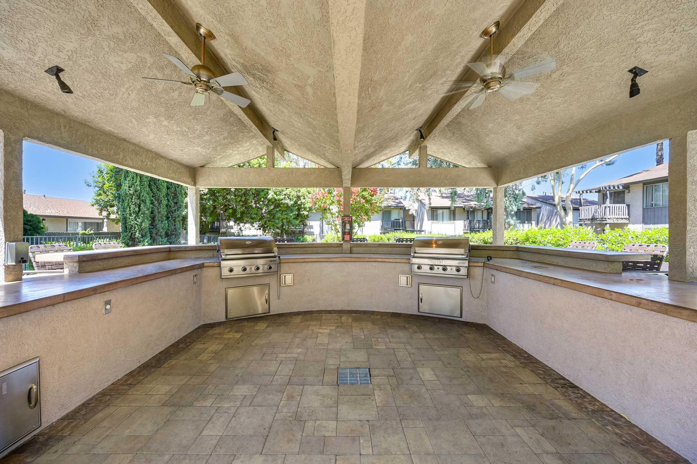 a large outdoor kitchen with grills