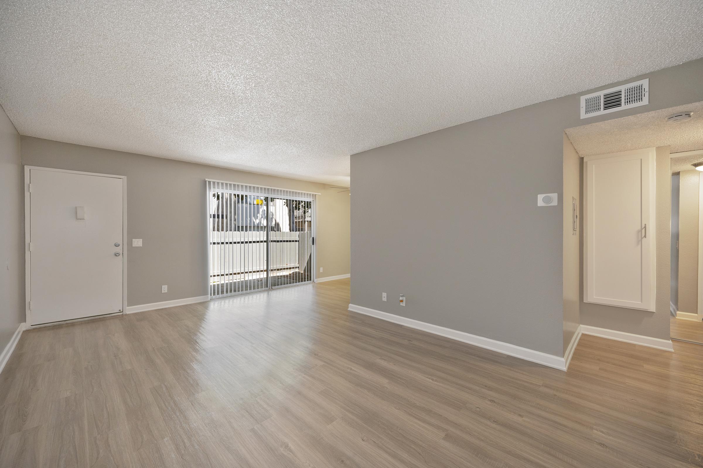 a large empty room with a wood floor