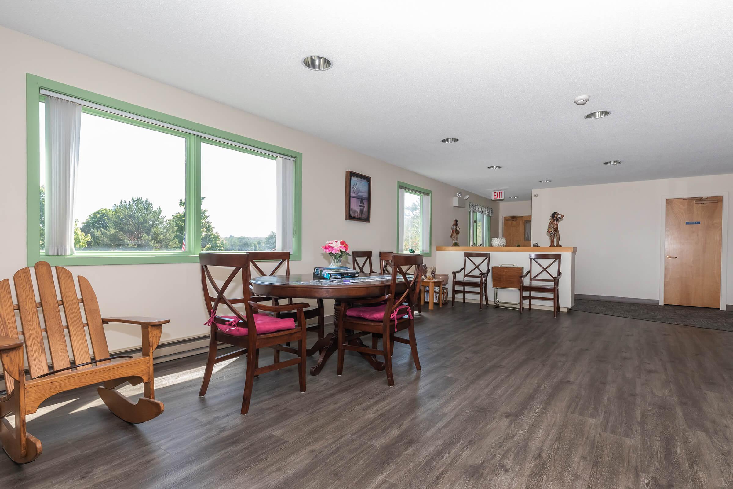 a living room filled with furniture on top of a wooden floor