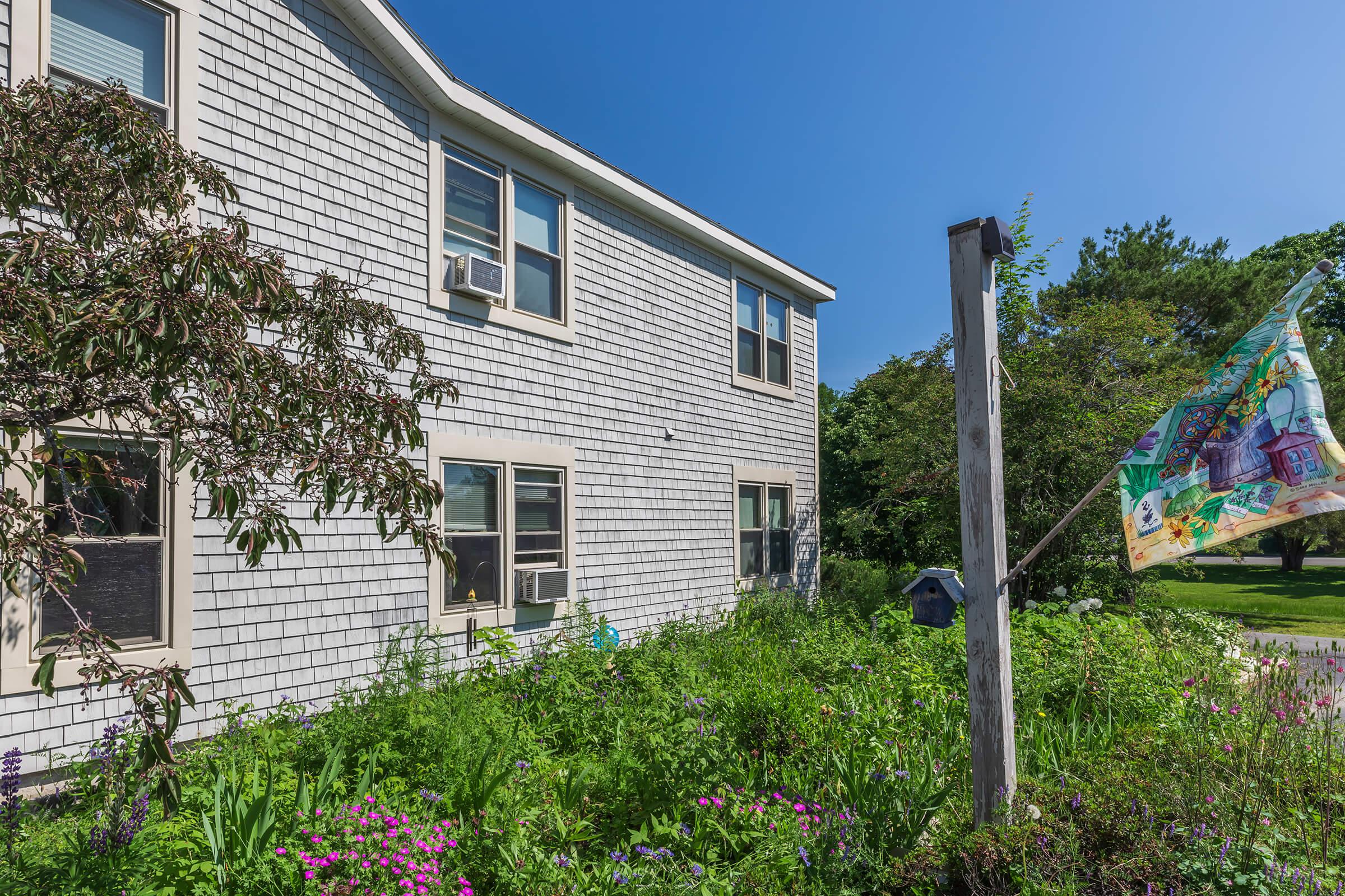 a house with bushes in front of a building