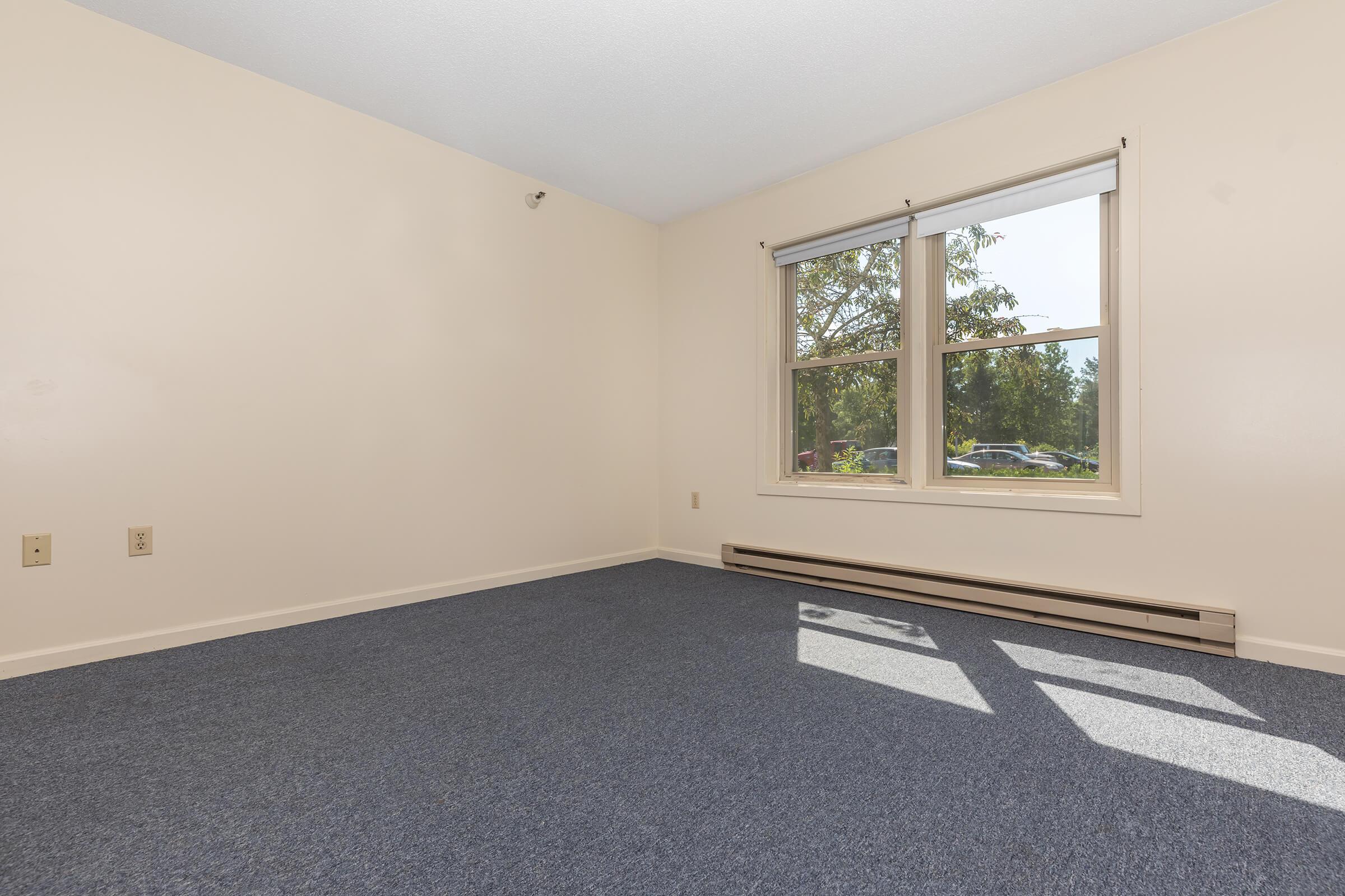 a bedroom with a large window